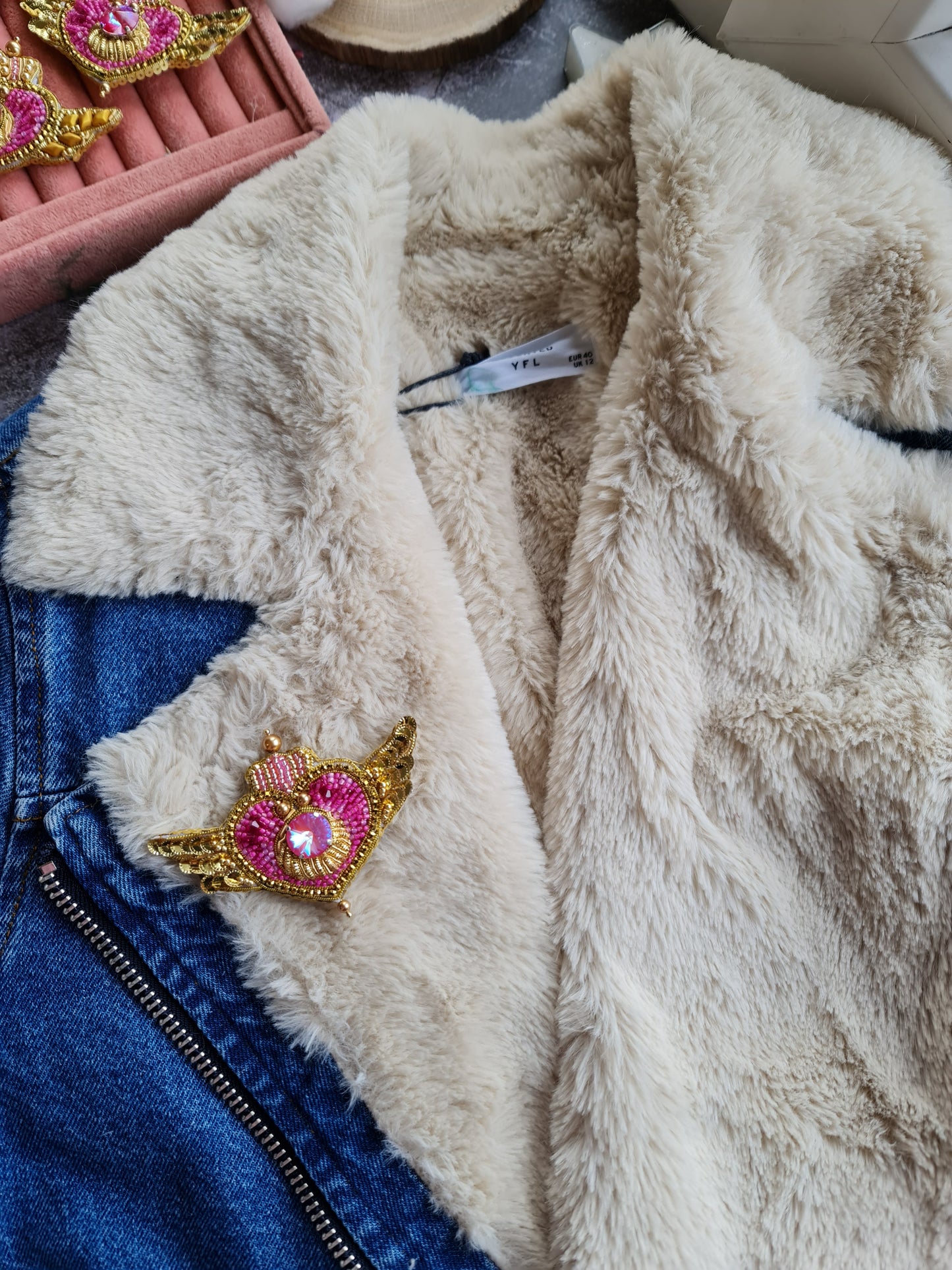 Anime-inspired Cosmic Heart Compact Brooch pinned on a jacket, showcasing its intricate beaded design and celestial heart details, measuring 2.36 inches x 3.74 inches