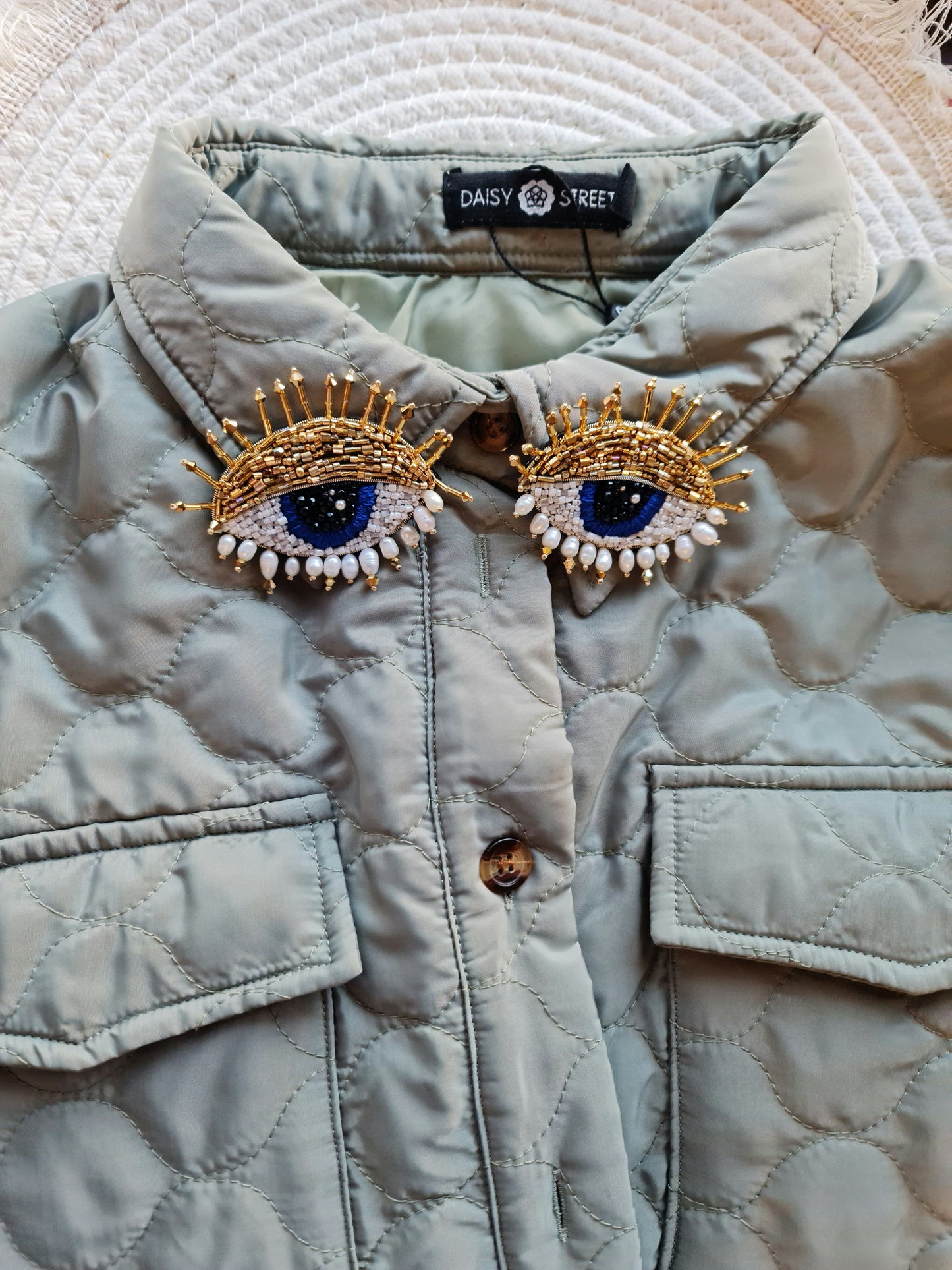 Model wearing the Enchanting Gaze Eye Brooch, an elegant accessory that adds a touch of mystique and sophistication to any outfit