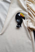 Black toucan beaded brooch hand embroidered with colorful yellow orange red beak, black beads, sequins, and crystal details