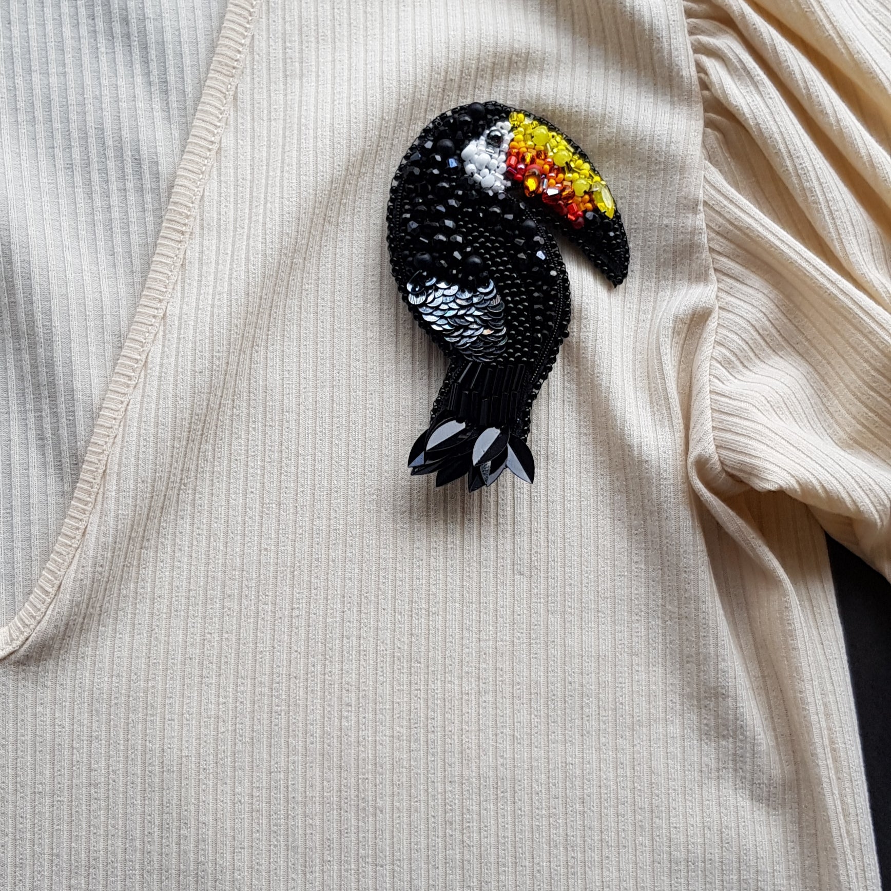 Black toucan beaded brooch hand embroidered with colorful yellow orange red beak, black beads, sequins, and crystal details