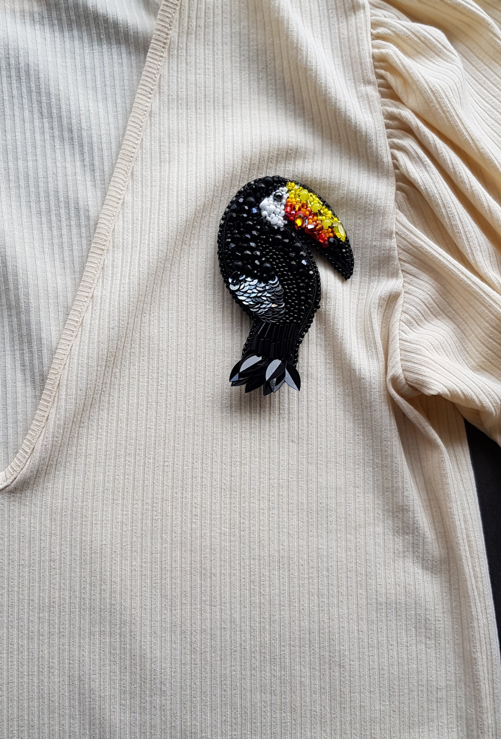 Black toucan beaded brooch hand embroidered with colorful yellow orange red beak, black beads, sequins, and crystal details