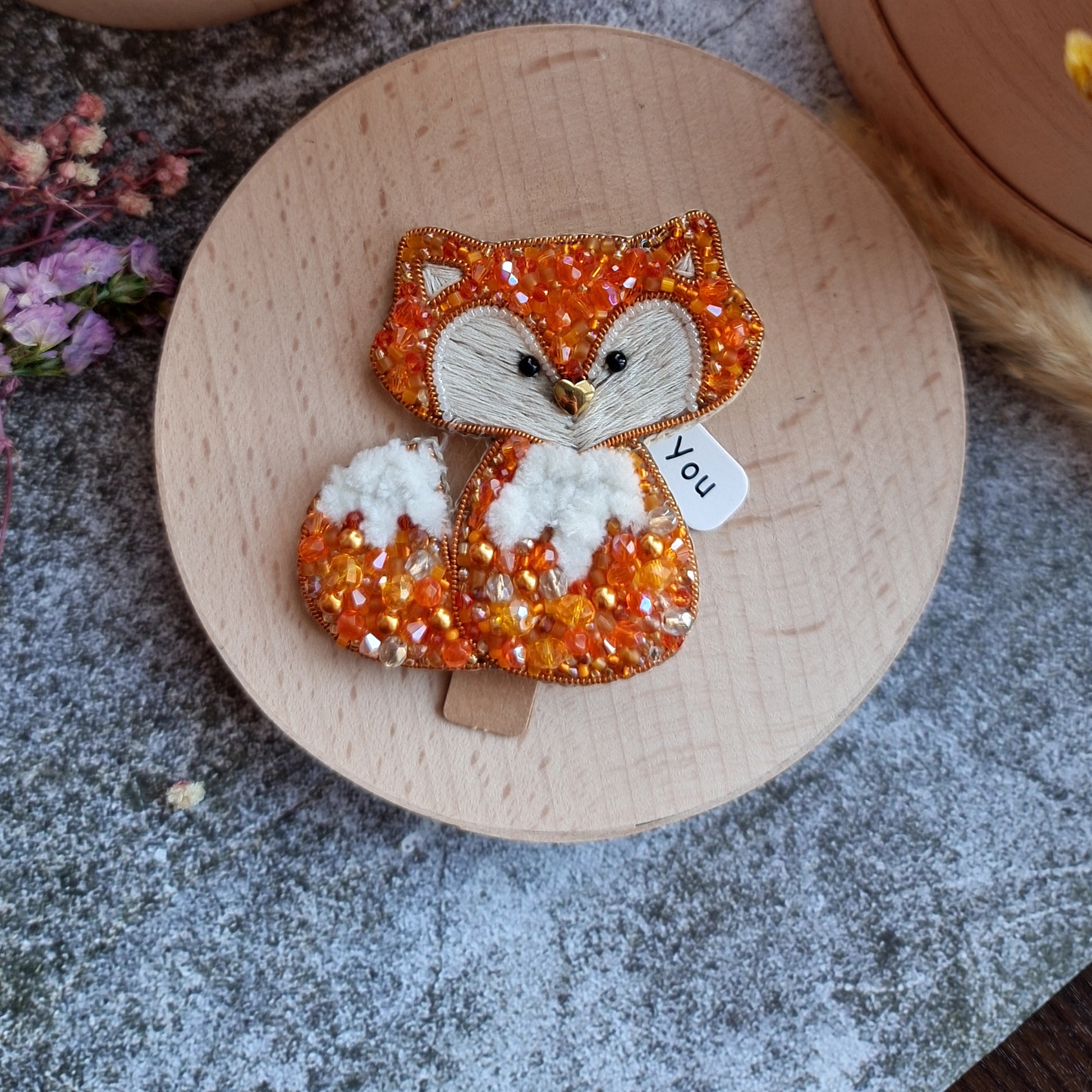 Handmade fox beaded brooch in orange tones with fluffy white tail detail and embroidered face