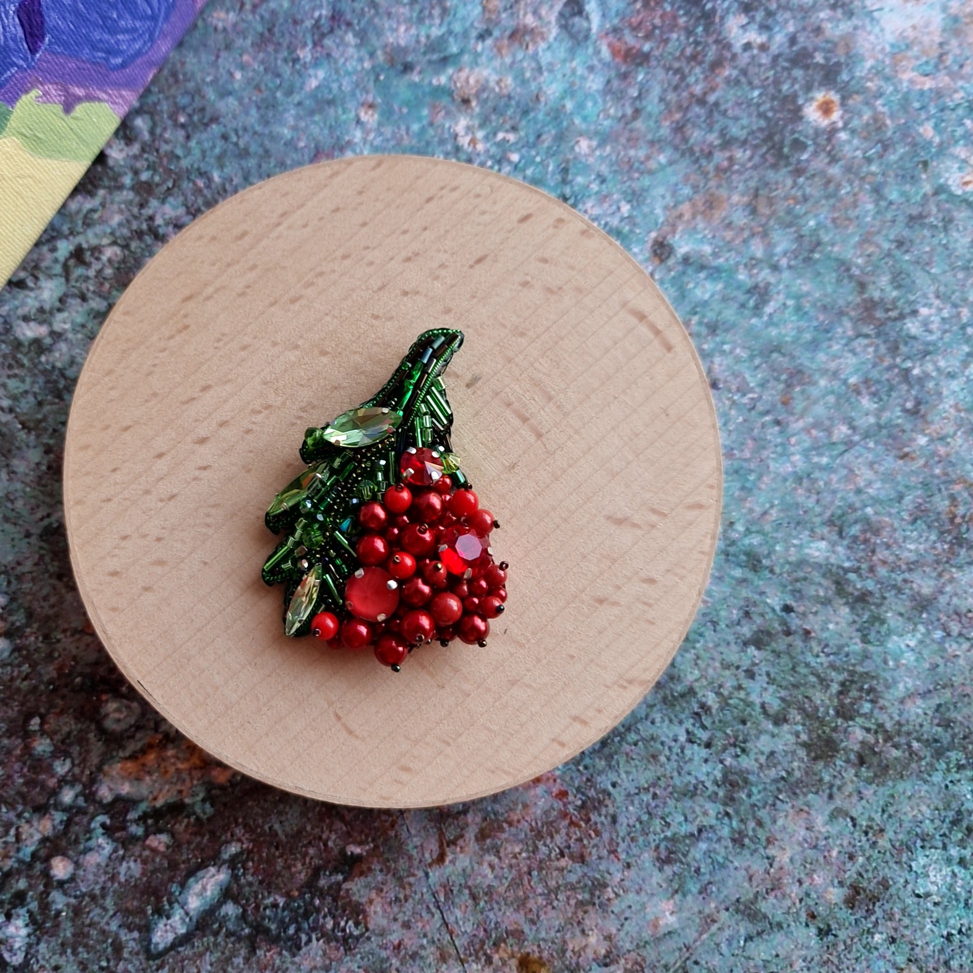 Red berry beaded brooch hand embroidered with green leaves crystals and bead details