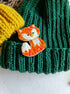 Handmade fox beaded brooch in orange tones with fluffy white tail detail and embroidered face