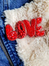 Red 'LOVE' patch on a textured surface