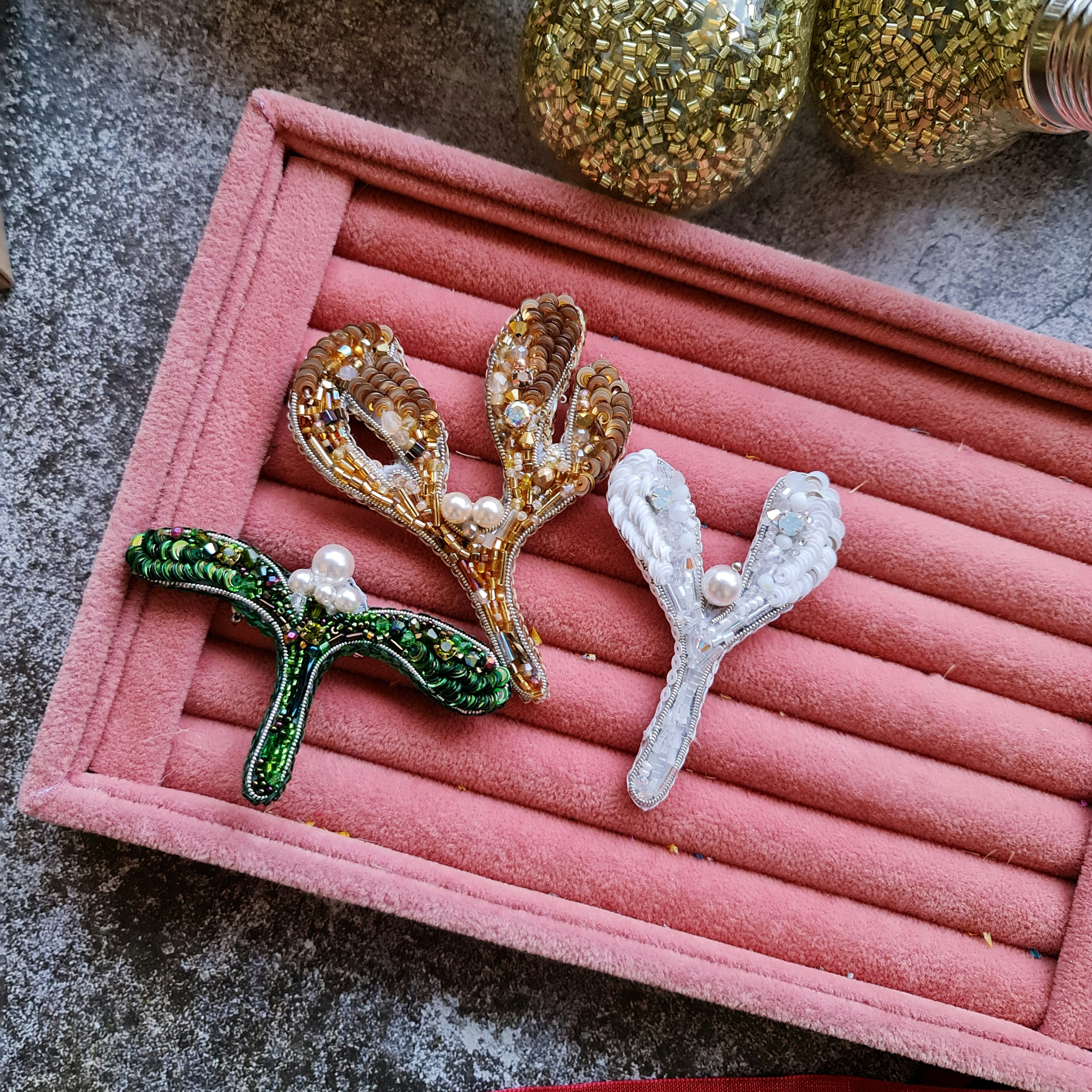 Handmade mistletoe brooch collection in gold, green and white, embroidered with beads, sequins, crystals and pearls, festive Christmas accessory.