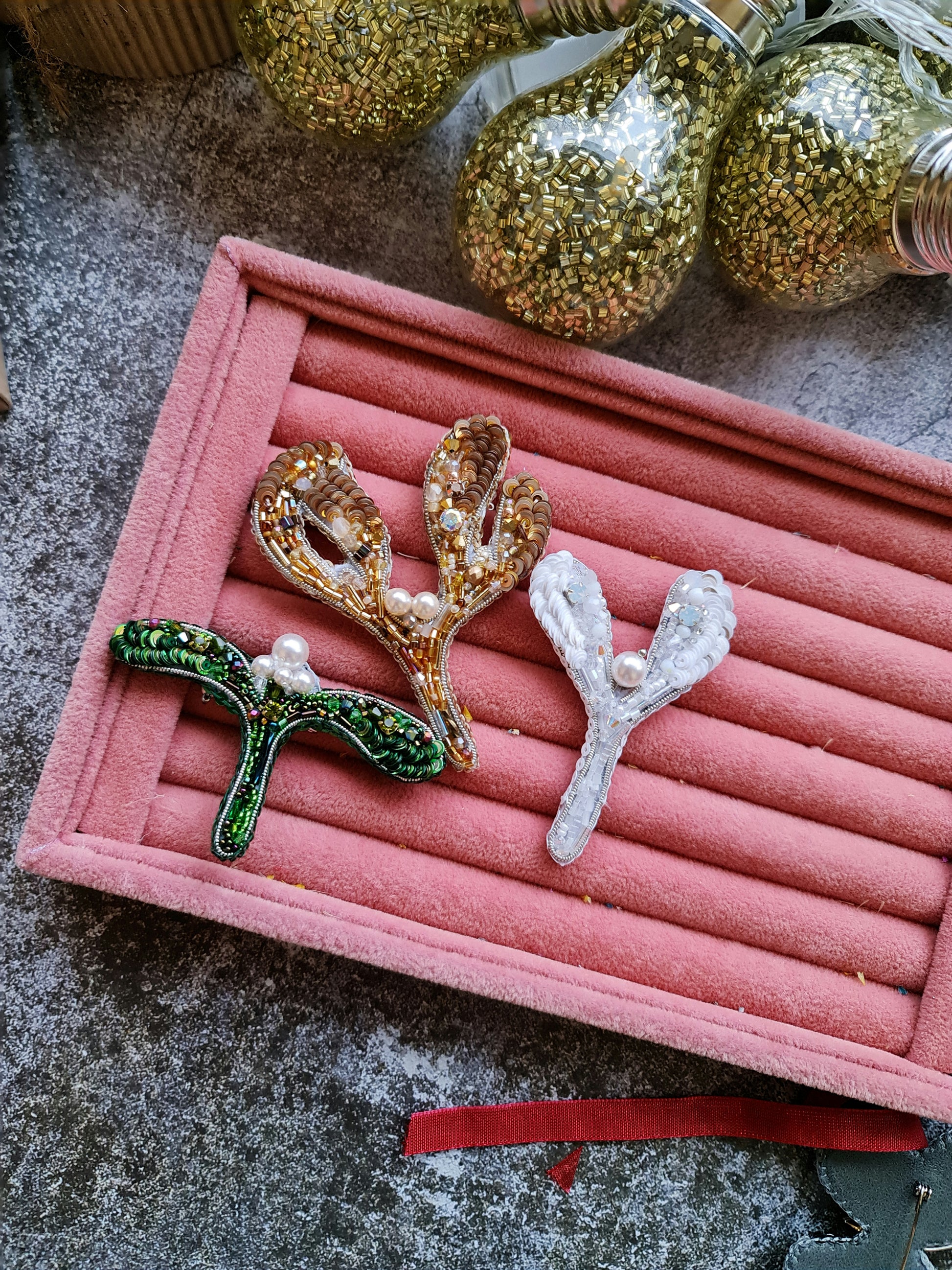 Handmade mistletoe brooch collection in gold, green and white, embroidered with beads, sequins, crystals and pearls, festive Christmas accessory.