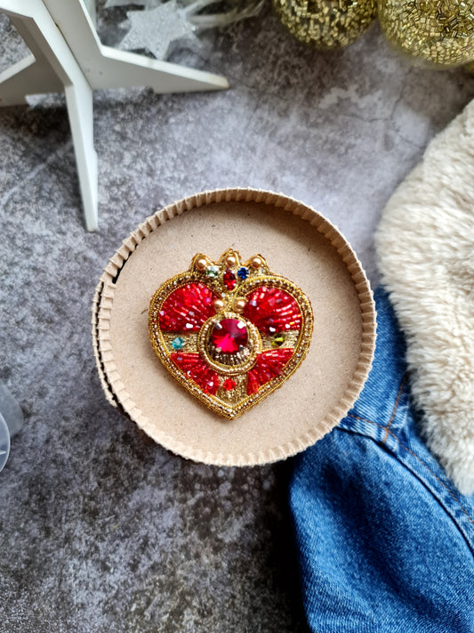 Handmade beaded brooch inspired by magical girl anime, featuring intricate embroidery and shimmering beads in a celestial moon design.