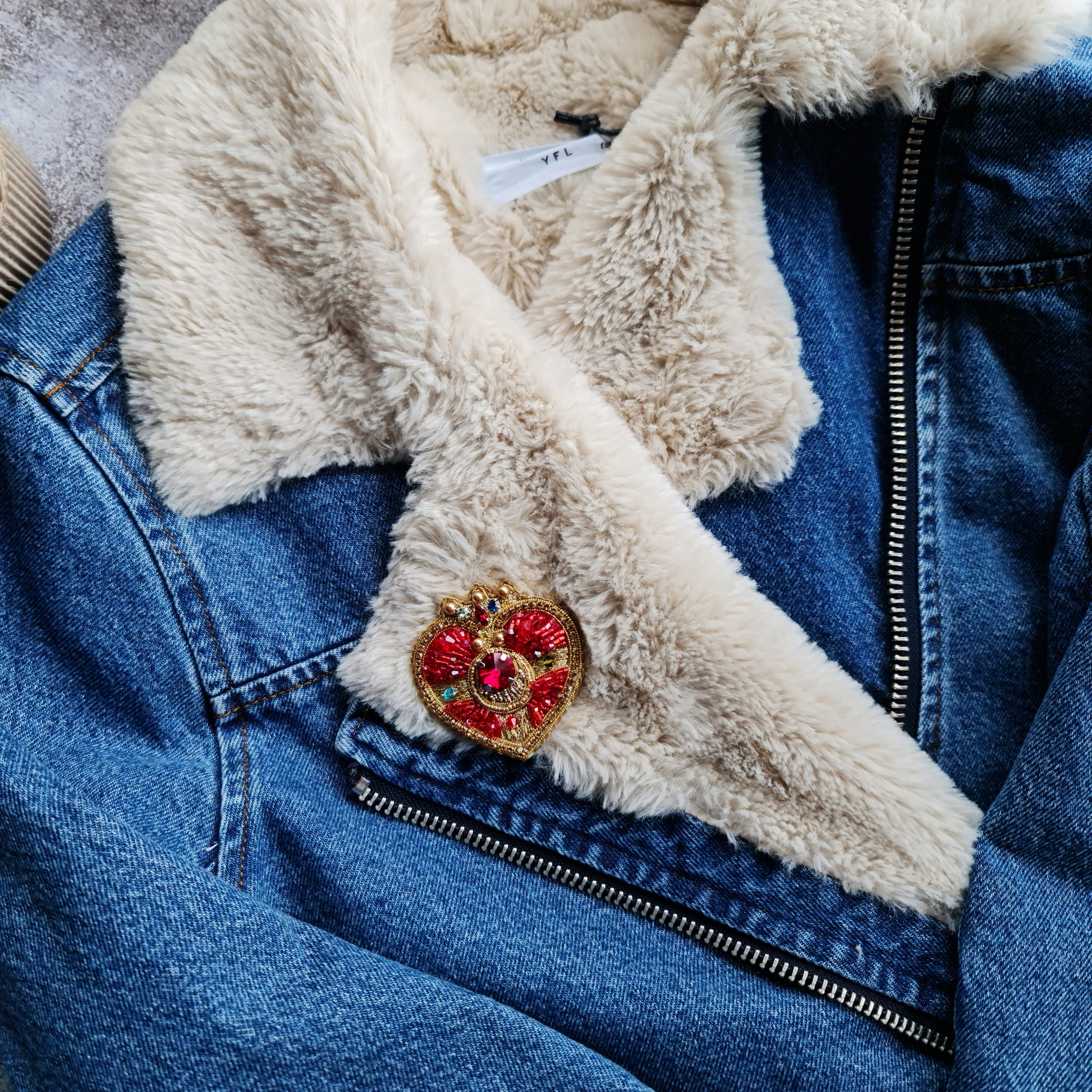 Anime-inspired moon brooch pinned to a denim jacket, adding a touch of kawaii fashion and celestial elegance