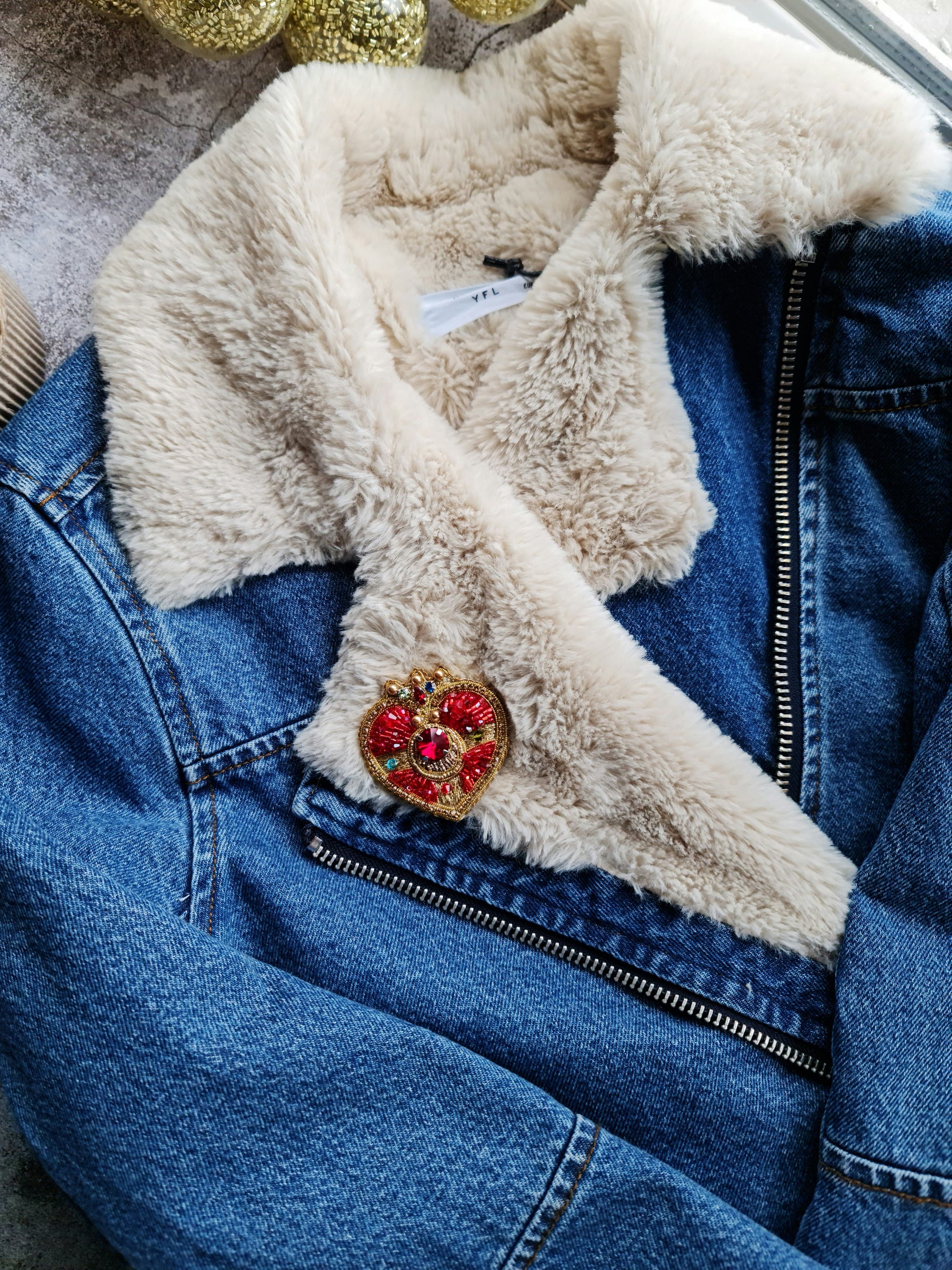 Anime-inspired moon brooch pinned to a denim jacket, adding a touch of kawaii fashion and celestial elegance