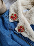 Anime-inspired moon brooch pinned to a denim jacket, adding a touch of kawaii fashion and celestial elegance