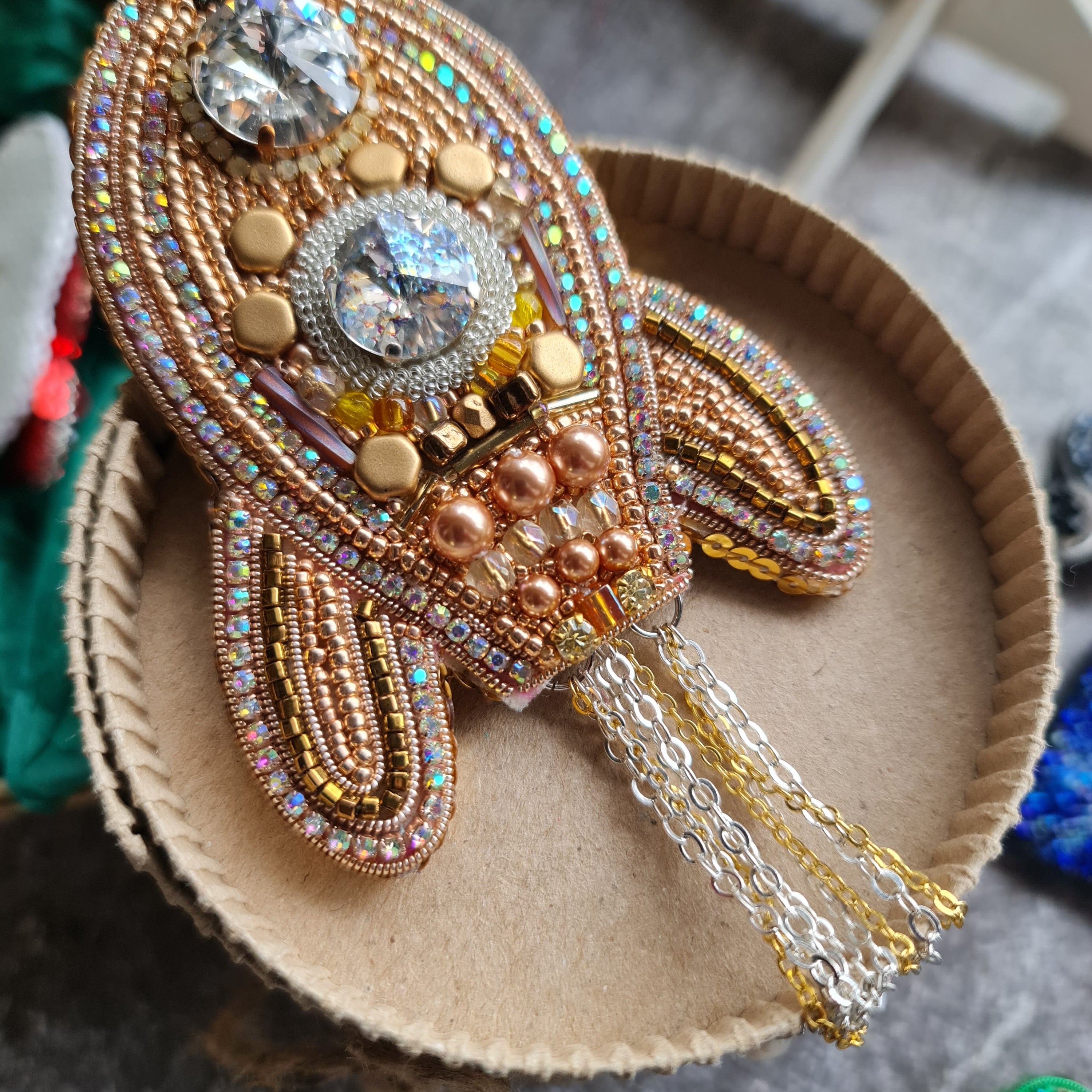 Decorative brooch with intricate design on a textured surface