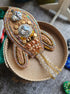 Decorative brooch with intricate design on a textured surface