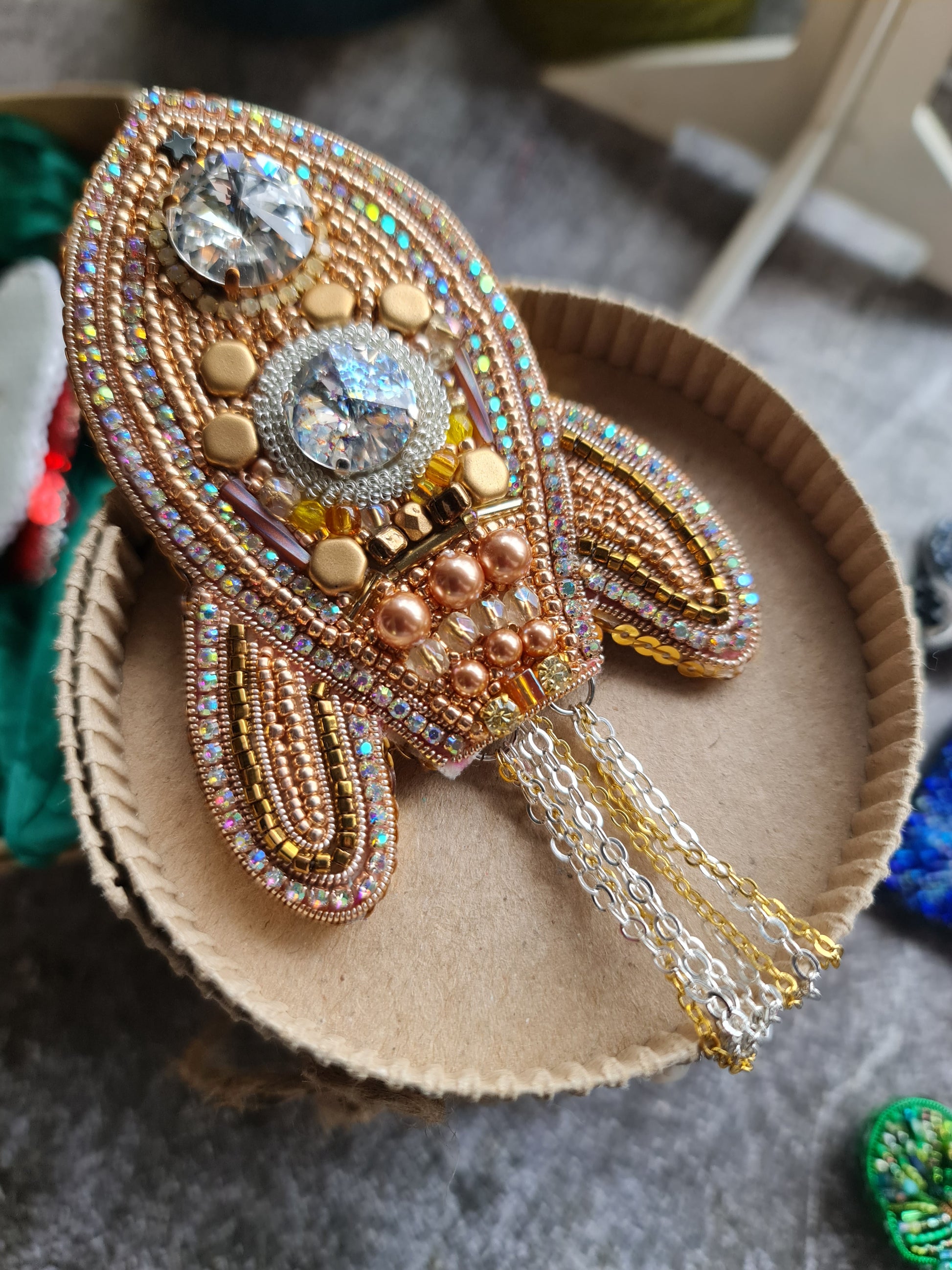 Decorative brooch with intricate design on a textured surface