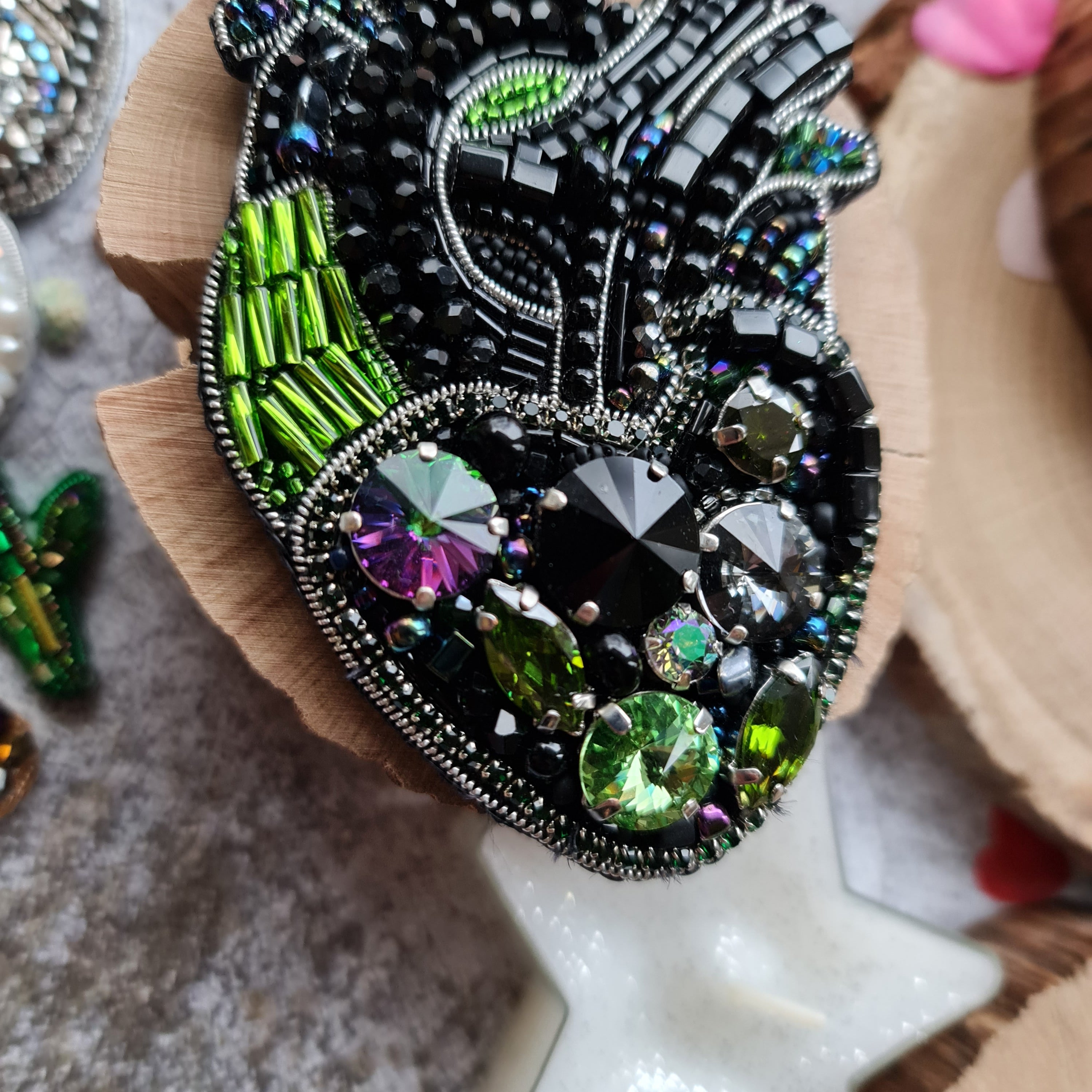 Black anatomical heart beaded brooch hand embroidered with green crystals and bead details