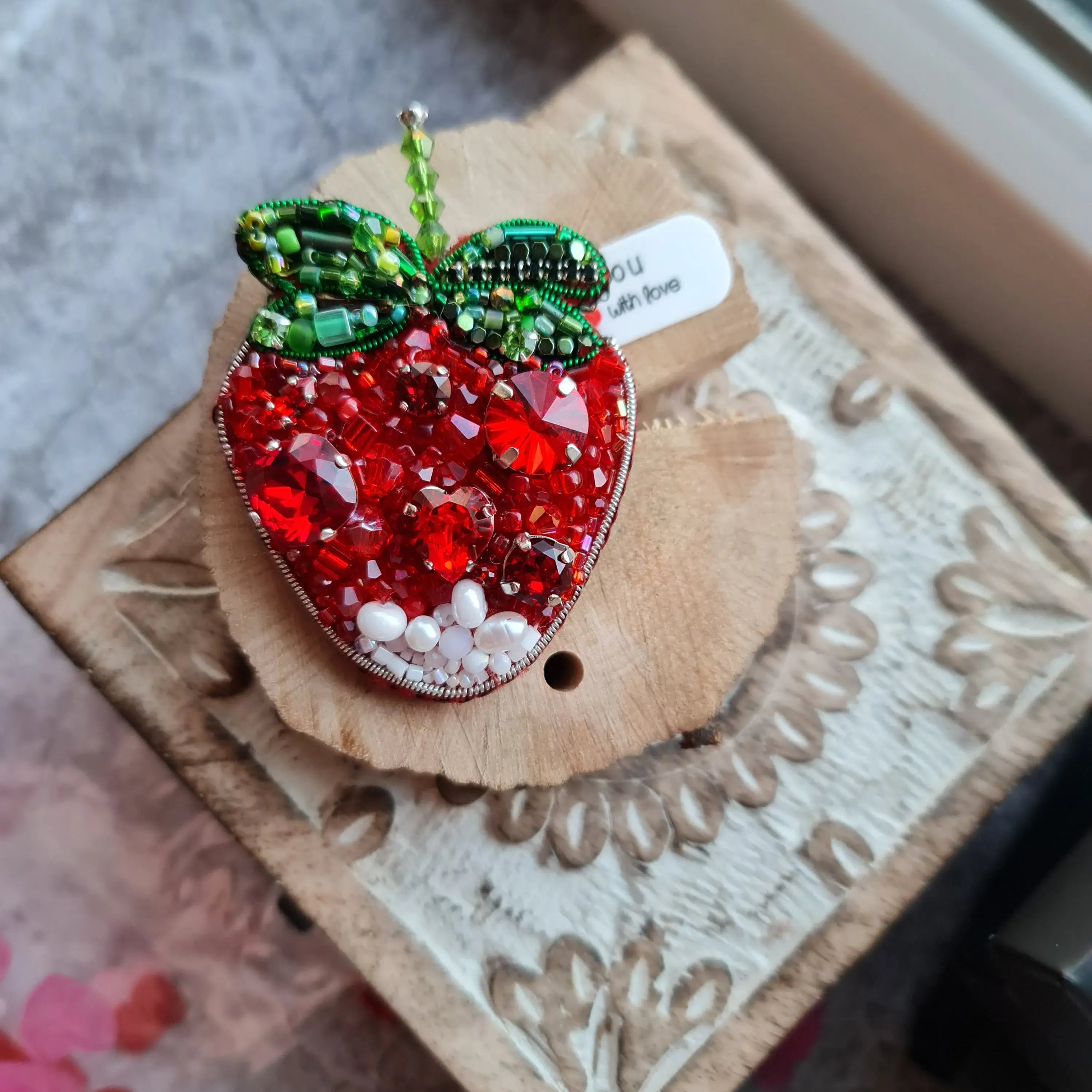 Hand embroidered red strawberry beaded brooch with green leaves