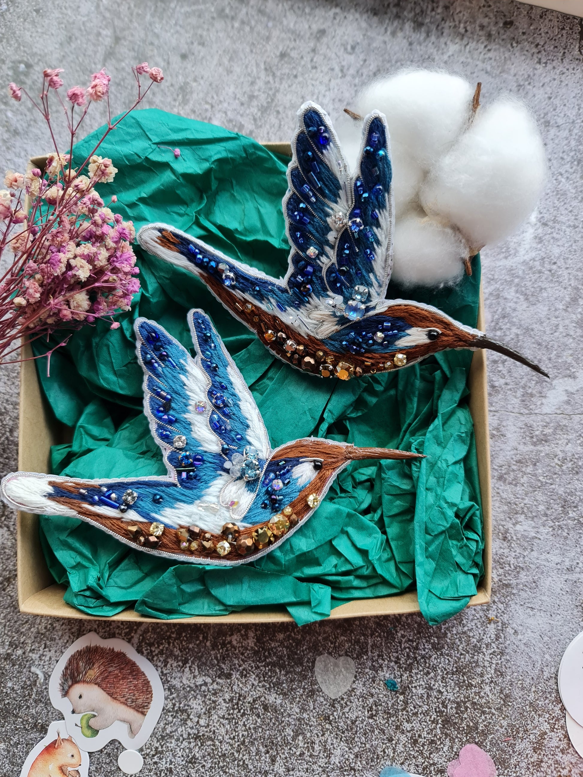 Blue hummingbird beaded brooch hand embroidered with blue white and brown thread, crystals, beads, and sparkling bird details