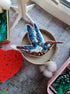 Blue hummingbird beaded brooch hand embroidered with blue white and brown thread, crystals, beads, and sparkling bird details