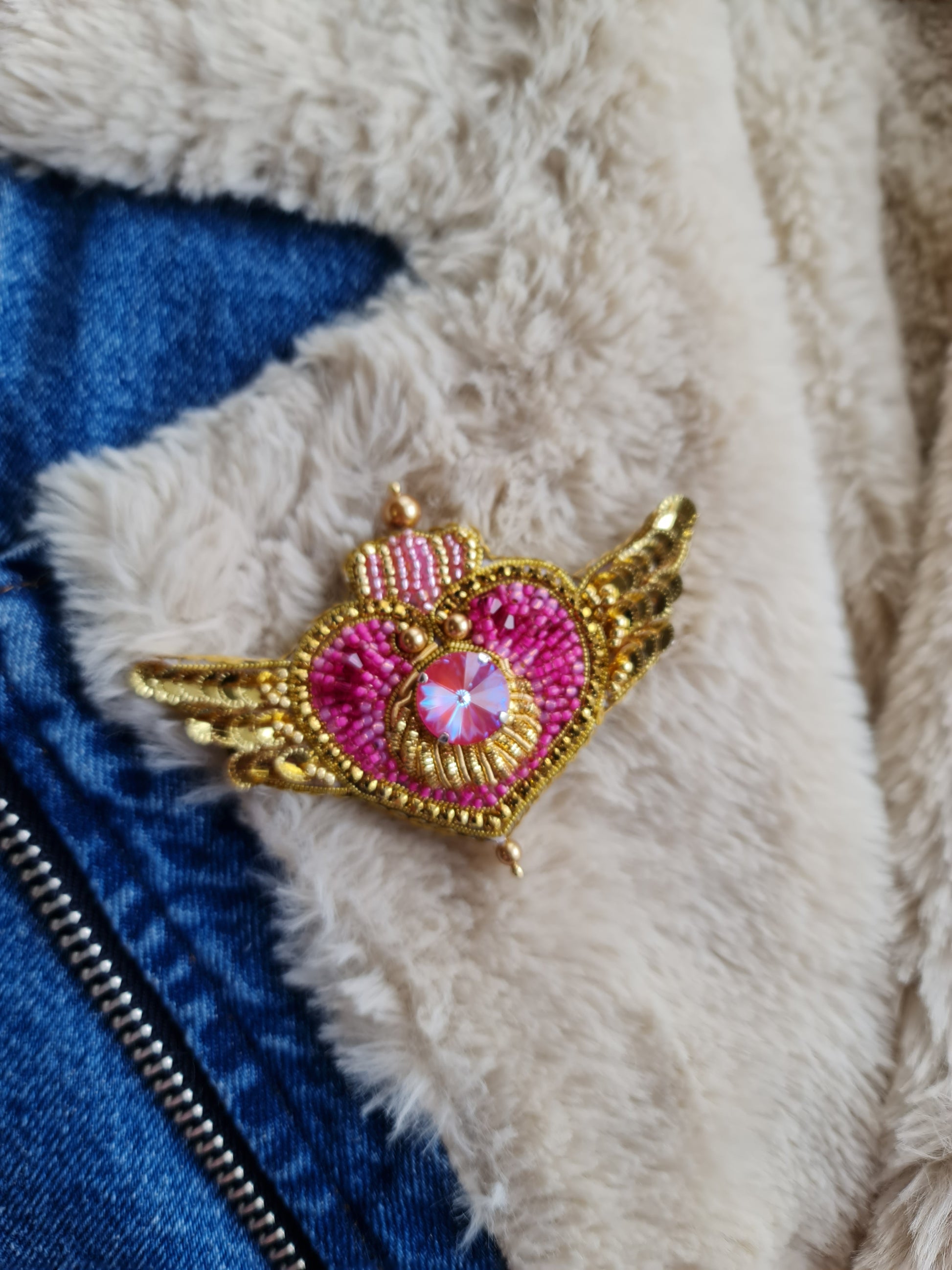 Anime-inspired Cosmic Heart Compact Brooch pinned on a jacket, showcasing its intricate beaded design and celestial heart details, measuring 2.36 inches x 3.74 inches
