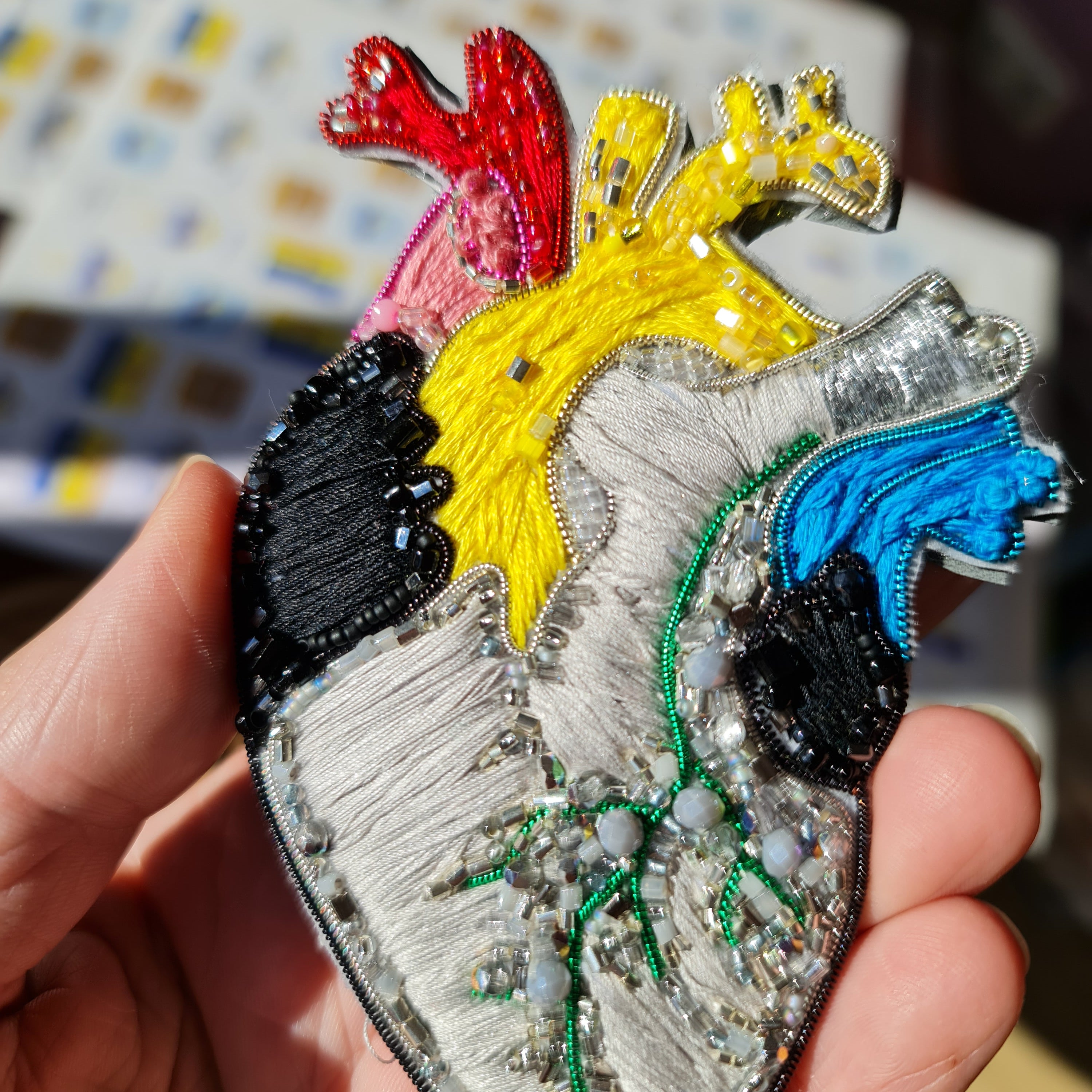 Colorful anatomical heart brooch hand embroidered with bright thread and bead details