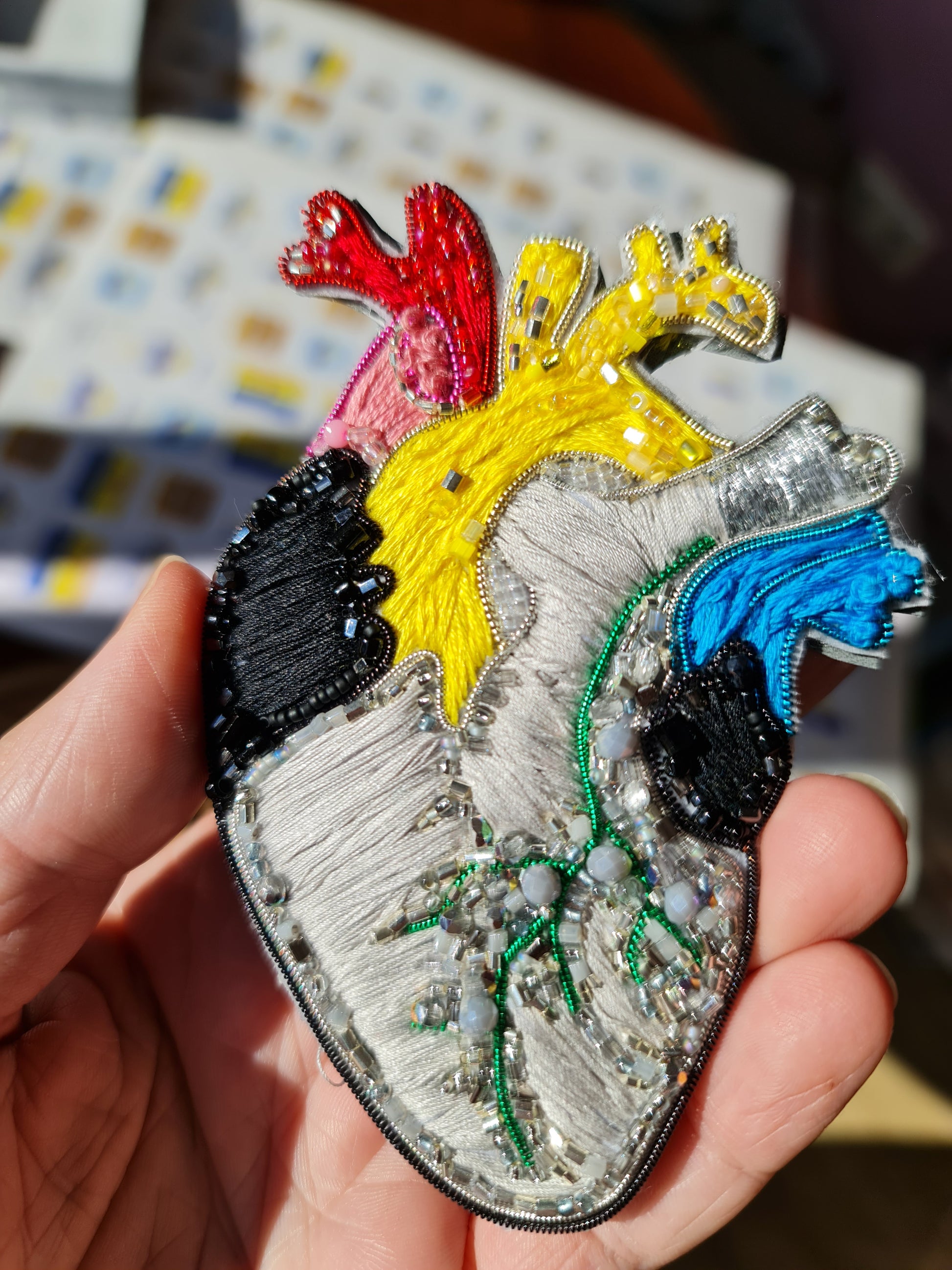 Colorful anatomical heart brooch hand embroidered with bright thread and bead details
