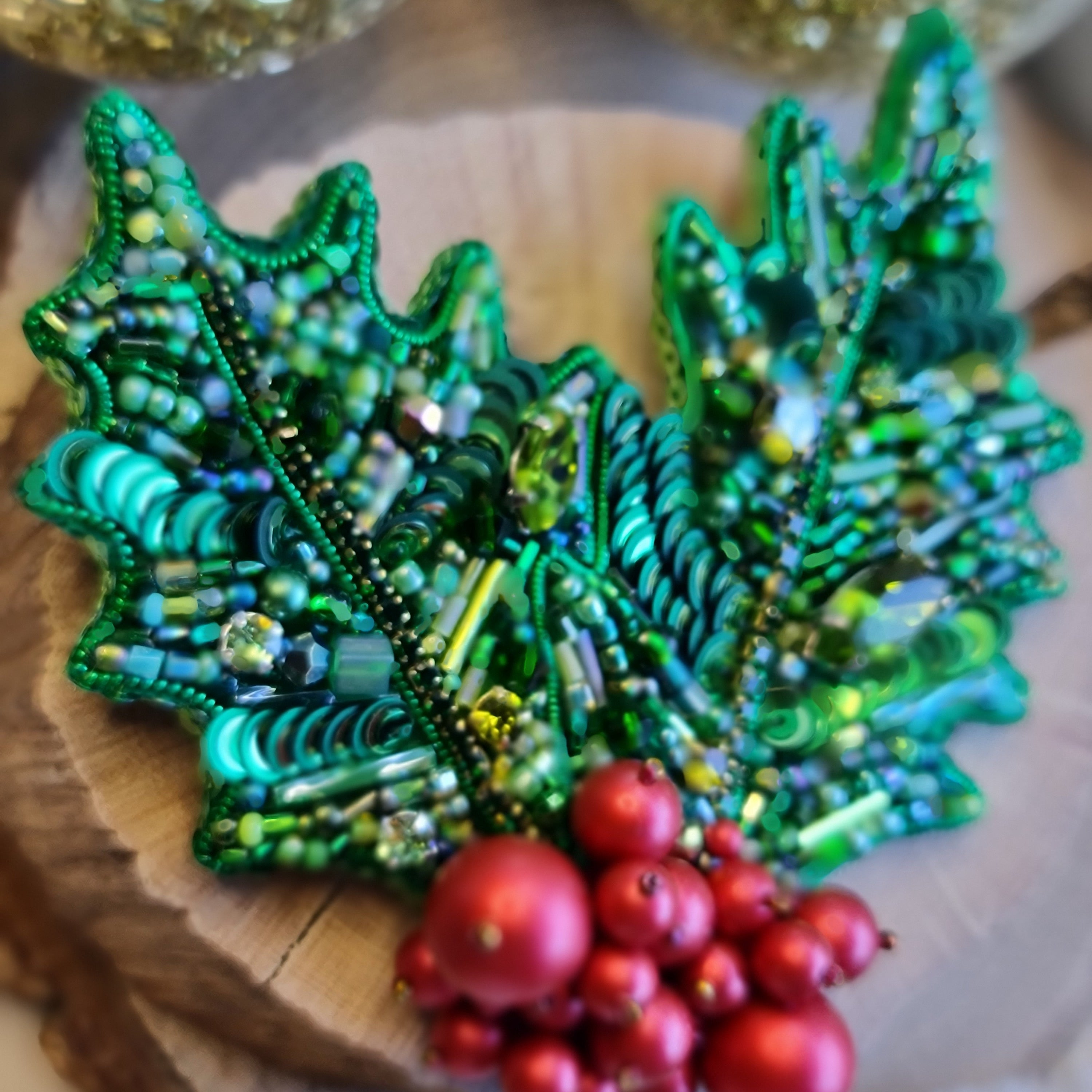 Handmade Christmas holly berry brooch with green beaded leaves and red berries, festive holiday pin, 7.5 x 8 cm.