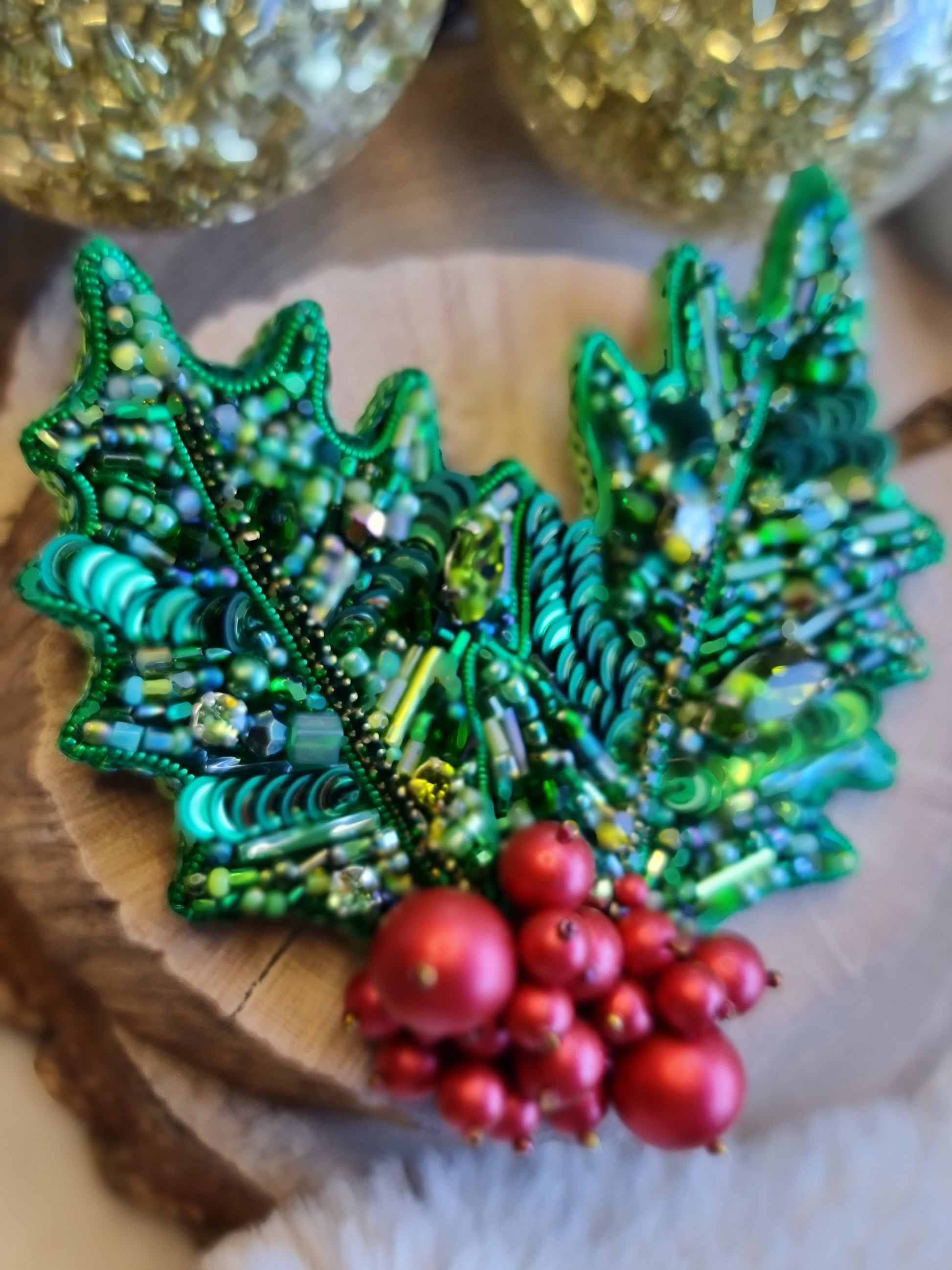 Handmade Christmas holly berry brooch with green beaded leaves and red berries, festive holiday pin, 7.5 x 8 cm.