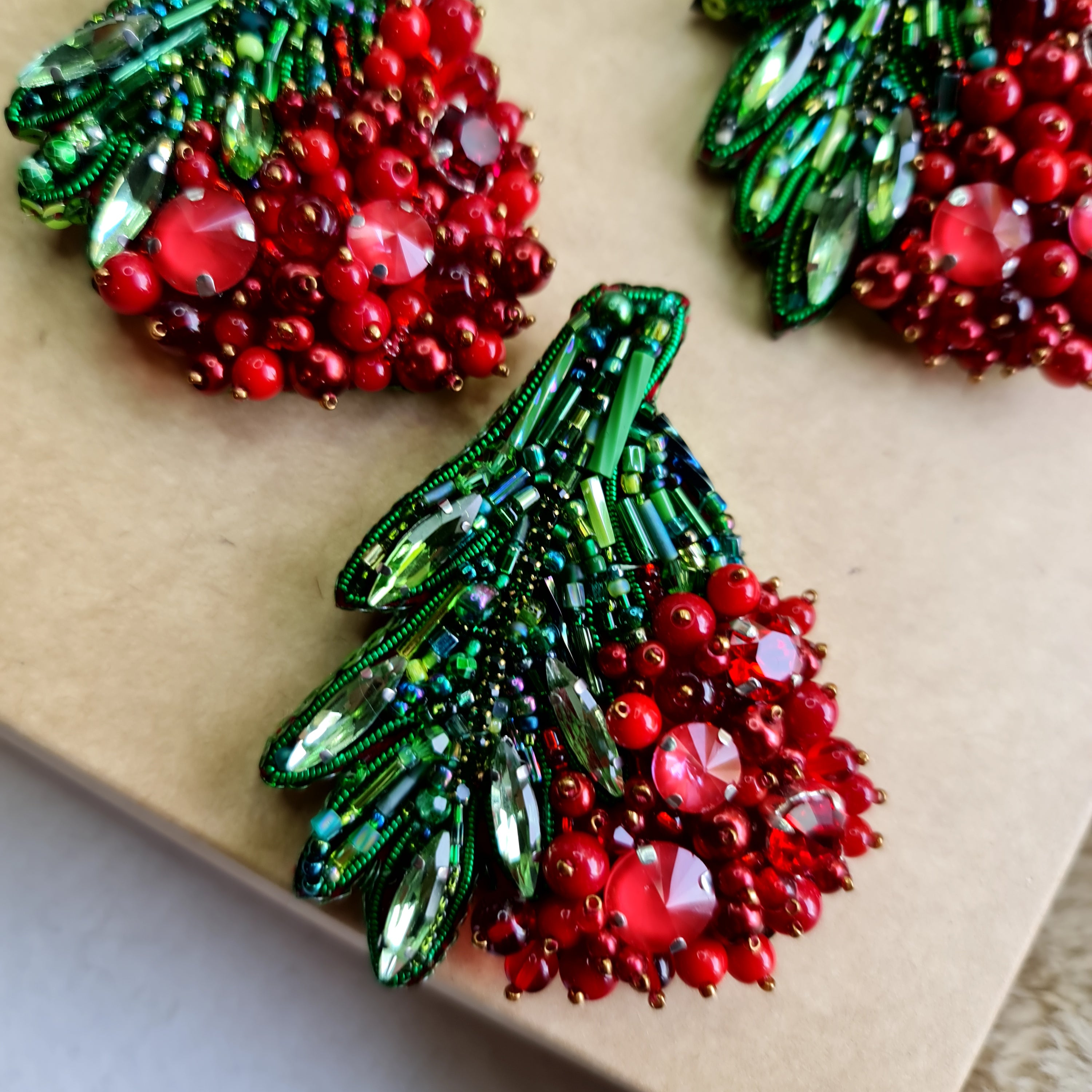 Red berry beaded brooch hand embroidered with green leaves crystals and bead details