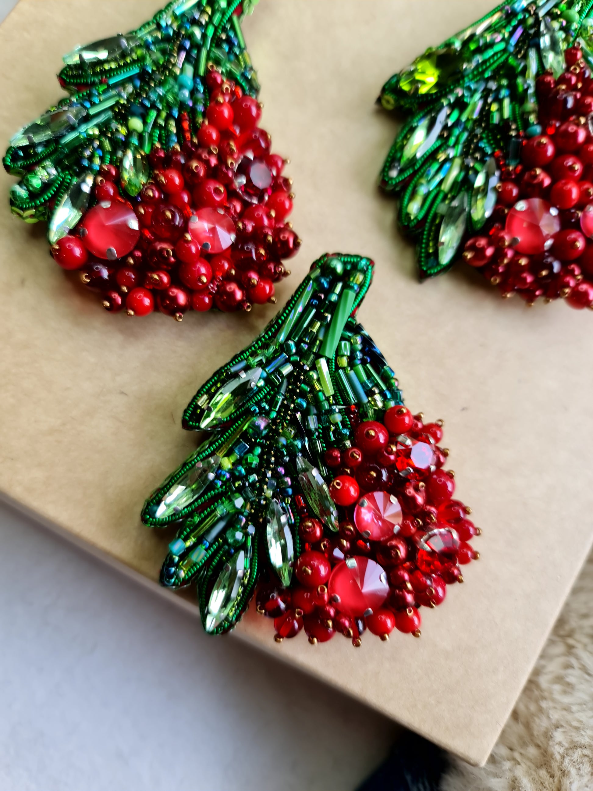 Red berry beaded brooch hand embroidered with green leaves crystals and bead details