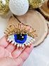 Close-up view of the intricate eye motif on the Enchanting Gaze Eye Brooch, showcasing detailed craftsmanship and unique design elements