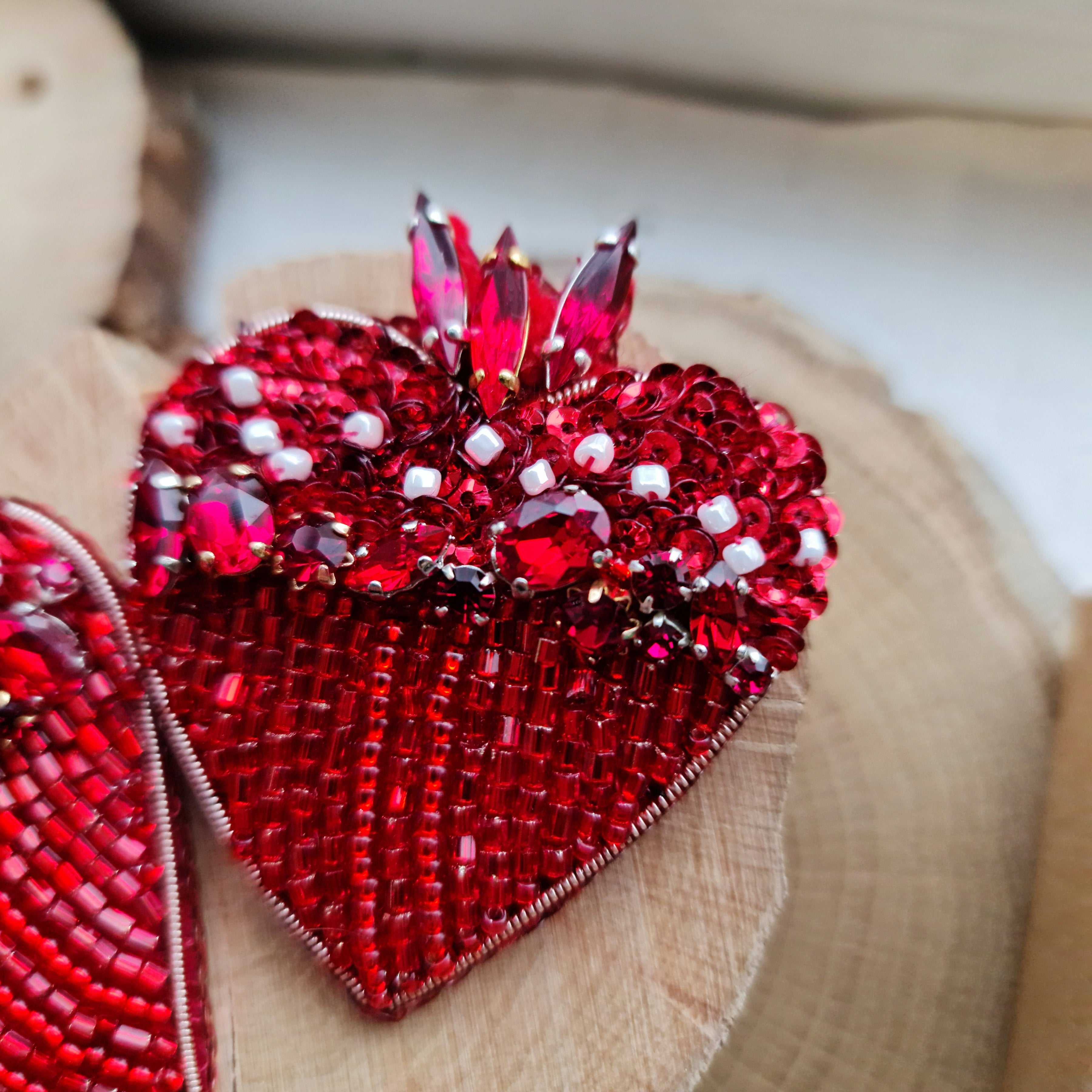 Handmade red heart beaded brooch with red beads, crystals and sequins, 6 × 6 cm, shown as a statement jewelry accessory.