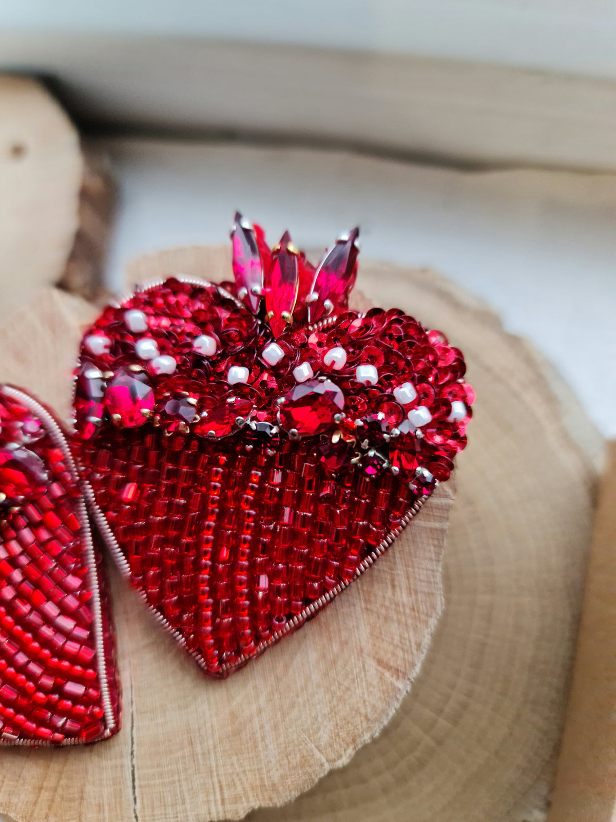 Handmade red heart beaded brooch with red beads, crystals and sequins, 6 × 6 cm, shown as a statement jewelry accessory.
