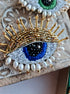 Lovers Blue Eye Beaded Brooch featuring a modern embroidery design with glass beads, crystals, and plastic beads arranged in a captivating blue eye, set on a felt backing, measuring 2.34 inches by 2.14 inches (6 cm x 5.5 cm).