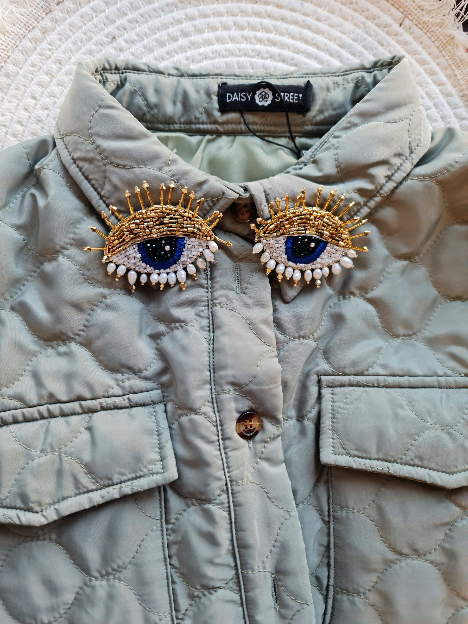 Model wearing the Enchanting Gaze Eye Brooch, an elegant accessory that adds a touch of mystique and sophistication to any outfit