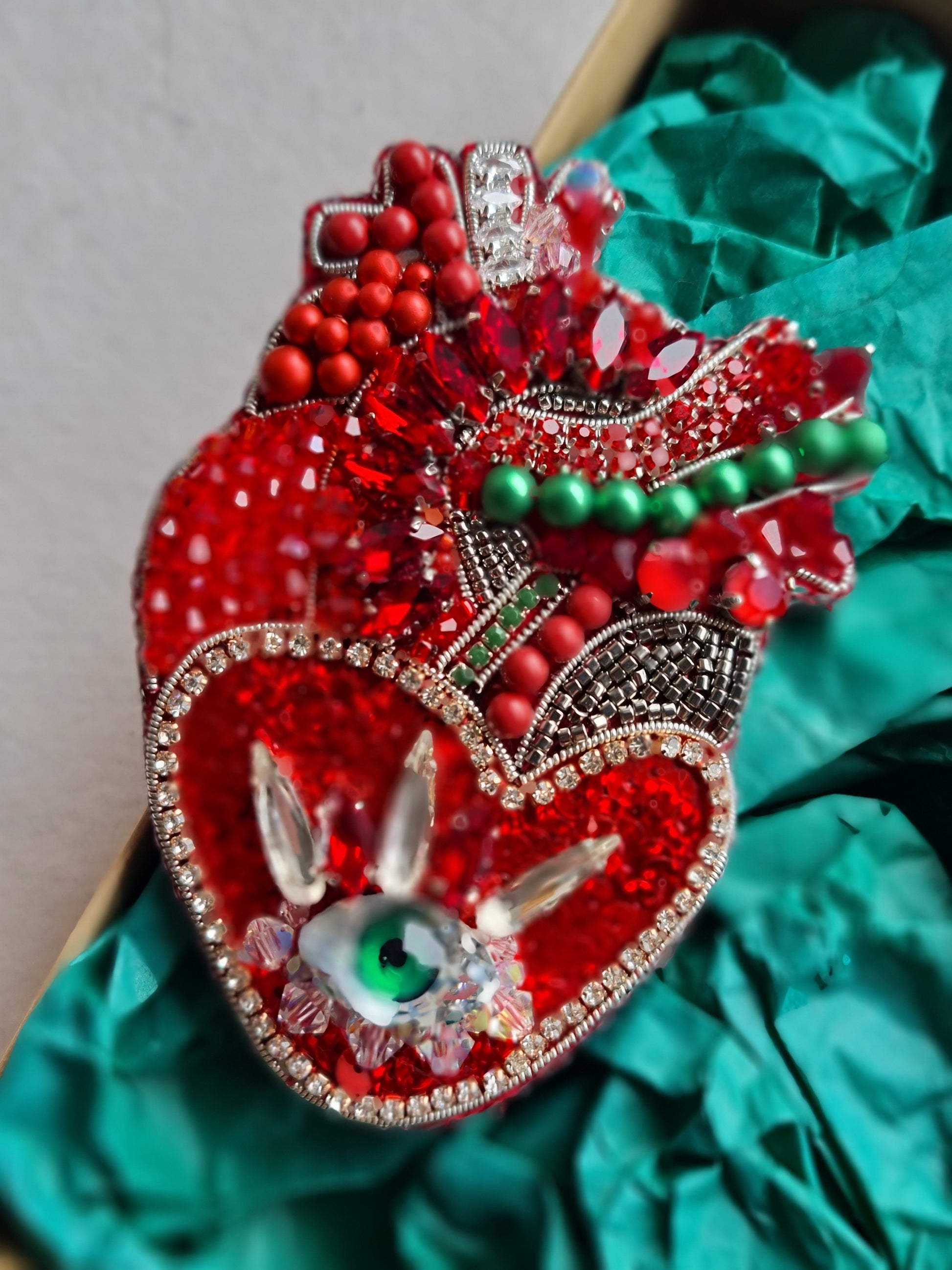 Red anatomical heart brooch with green eye, hand embroidered with beads and crystals