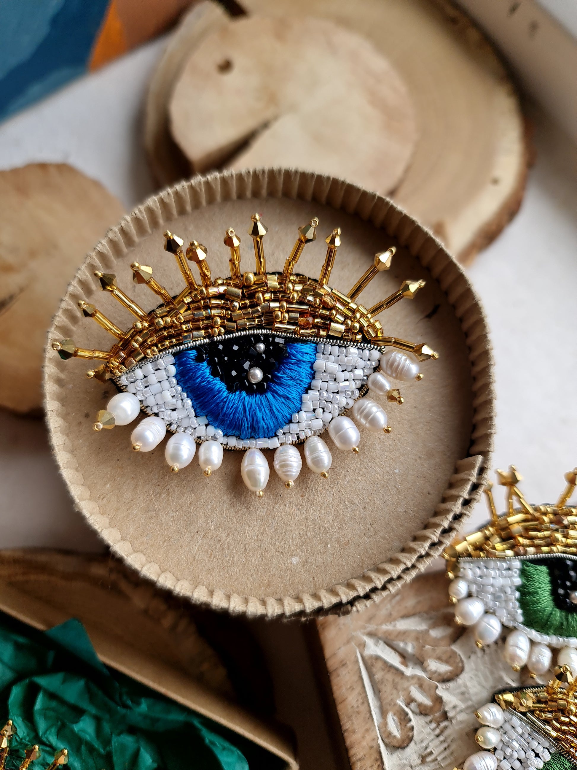 Model wearing the Enchanting Gaze Eye Brooch, an elegant accessory that adds a touch of mystique and sophistication to any outfit