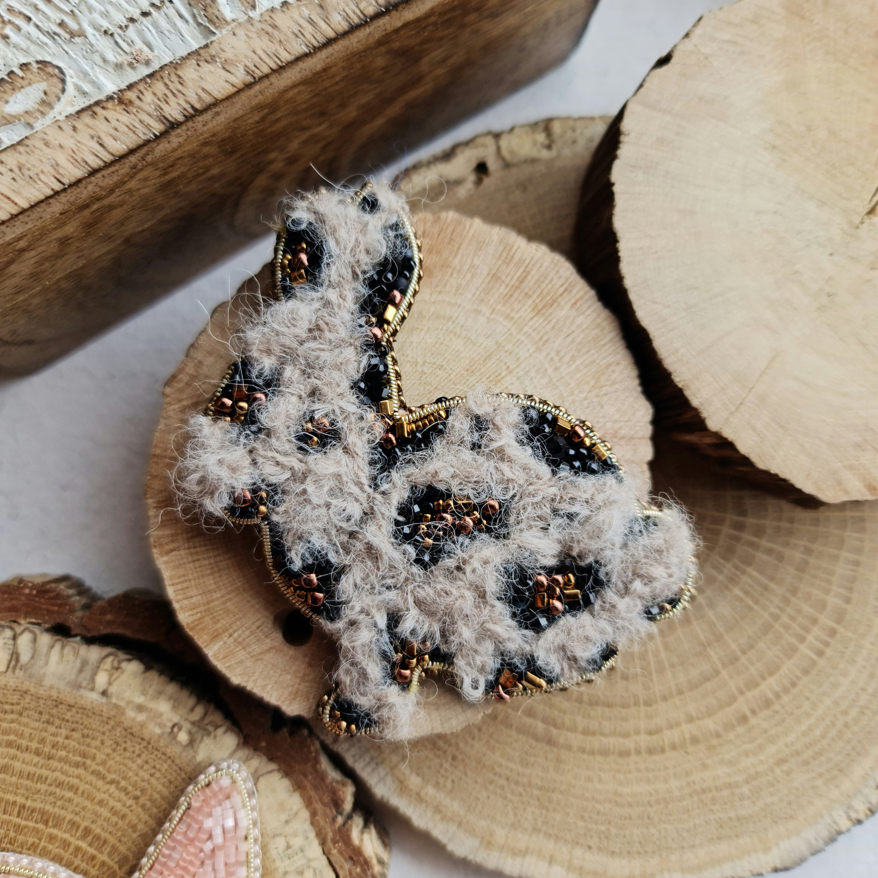 Spotted bunny beaded brooch hand embroidered with fluffy texture black spots and gold details