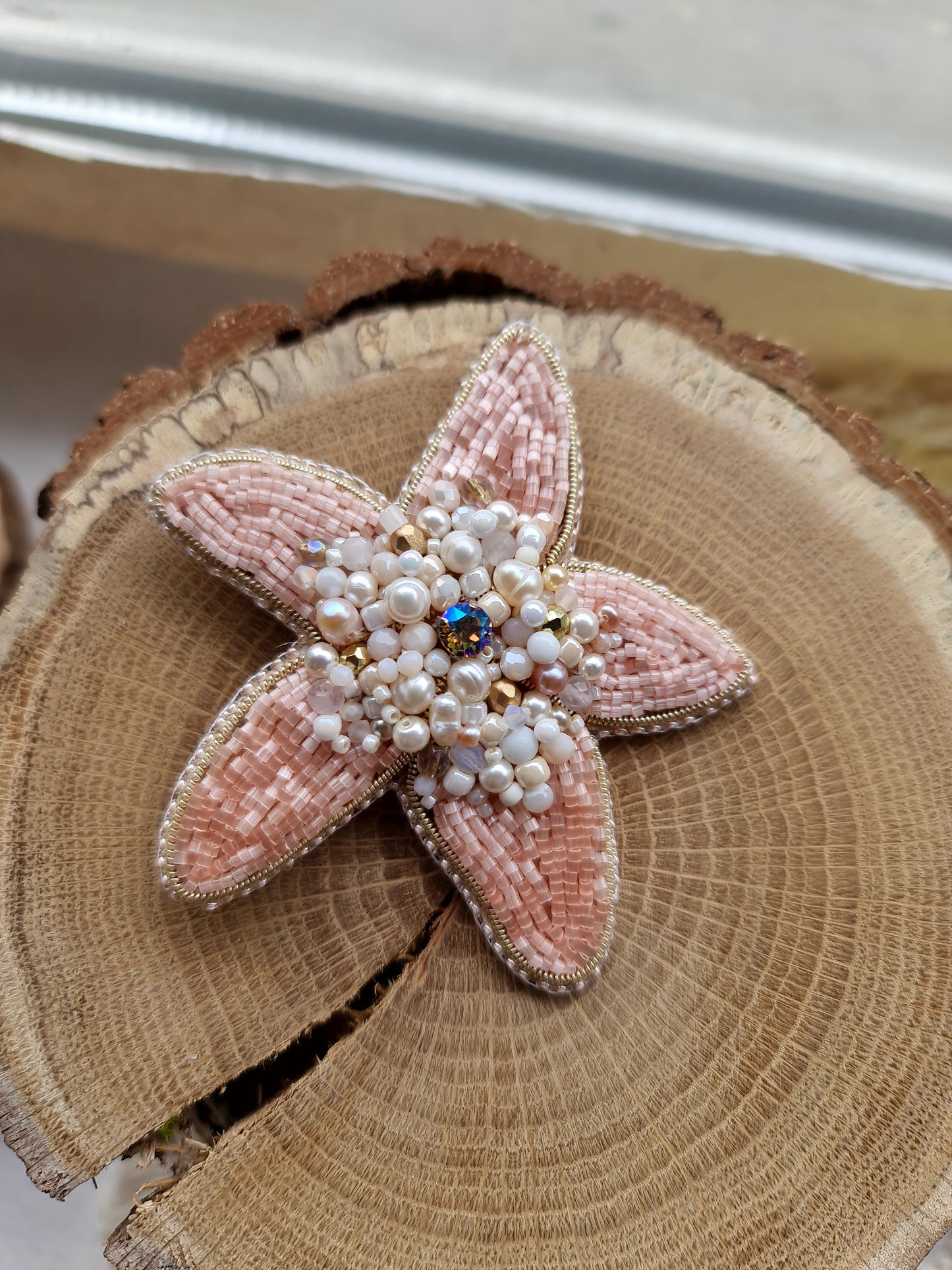 Close-up of the Stellar Seas Starfish Brooch showcasing detailed beadwork and embroidery with delicate Japanese beads, crystals, and pearls on a starfish design.