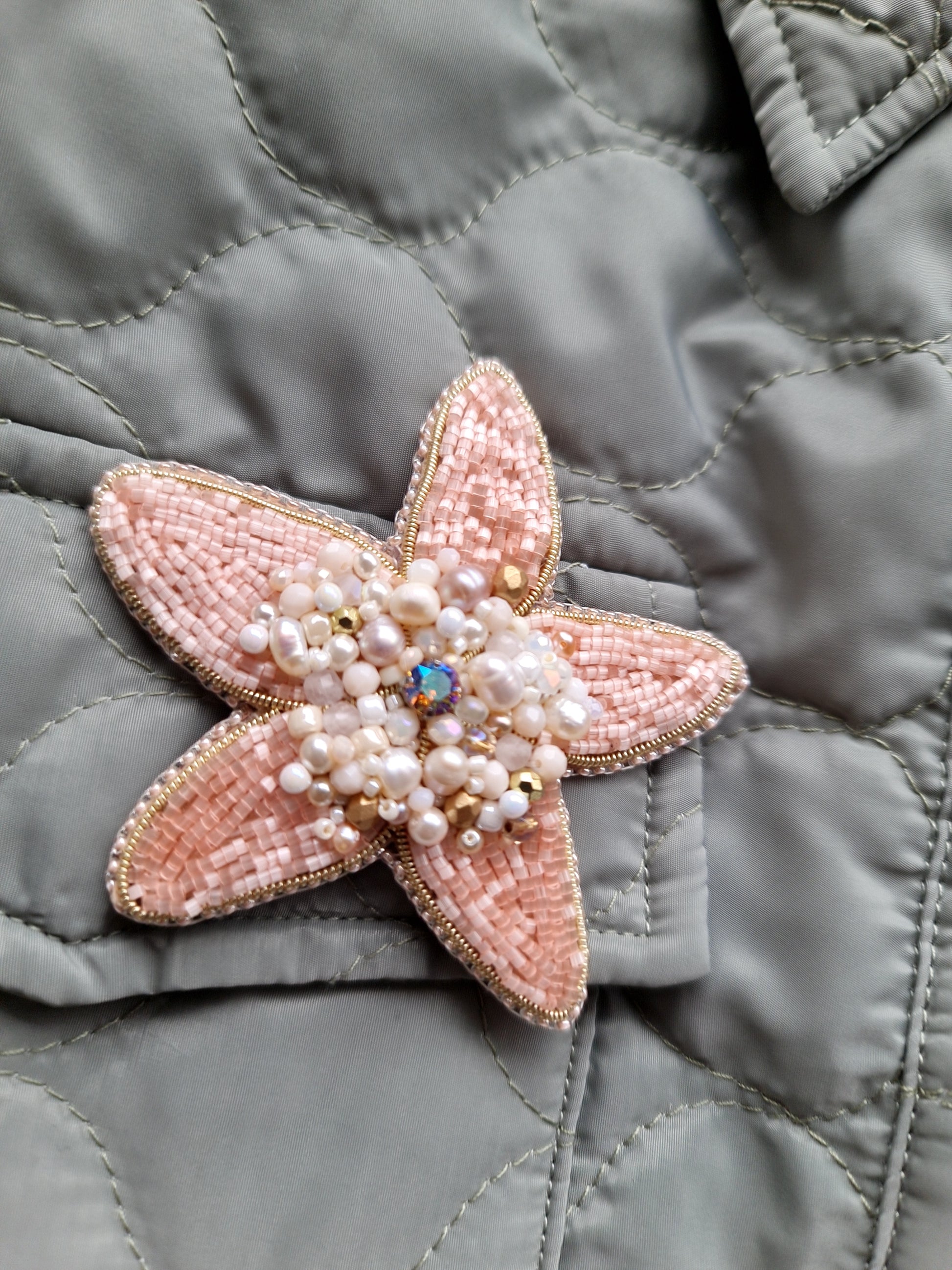 Close-up of the Stellar Seas Starfish Brooch showcasing detailed beadwork and embroidery with delicate Japanese beads, crystals, and pearls on a starfish design.