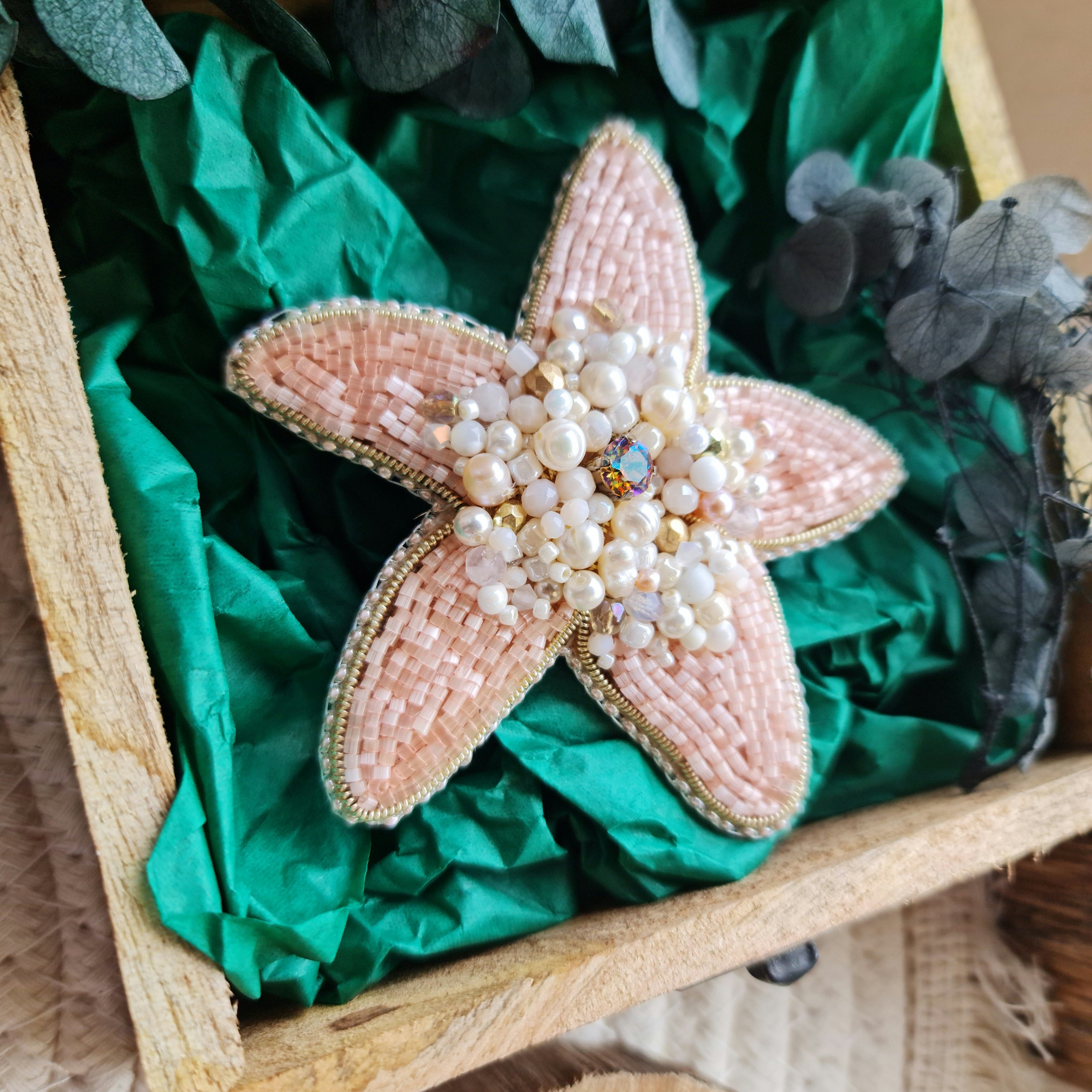 Close-up of the Stellar Seas Starfish Brooch showcasing detailed beadwork and embroidery with delicate Japanese beads, crystals, and pearls on a starfish design.