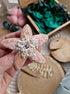 Close-up of the Stellar Seas Starfish Brooch showcasing detailed beadwork and embroidery with delicate Japanese beads, crystals, and pearls on a starfish design.