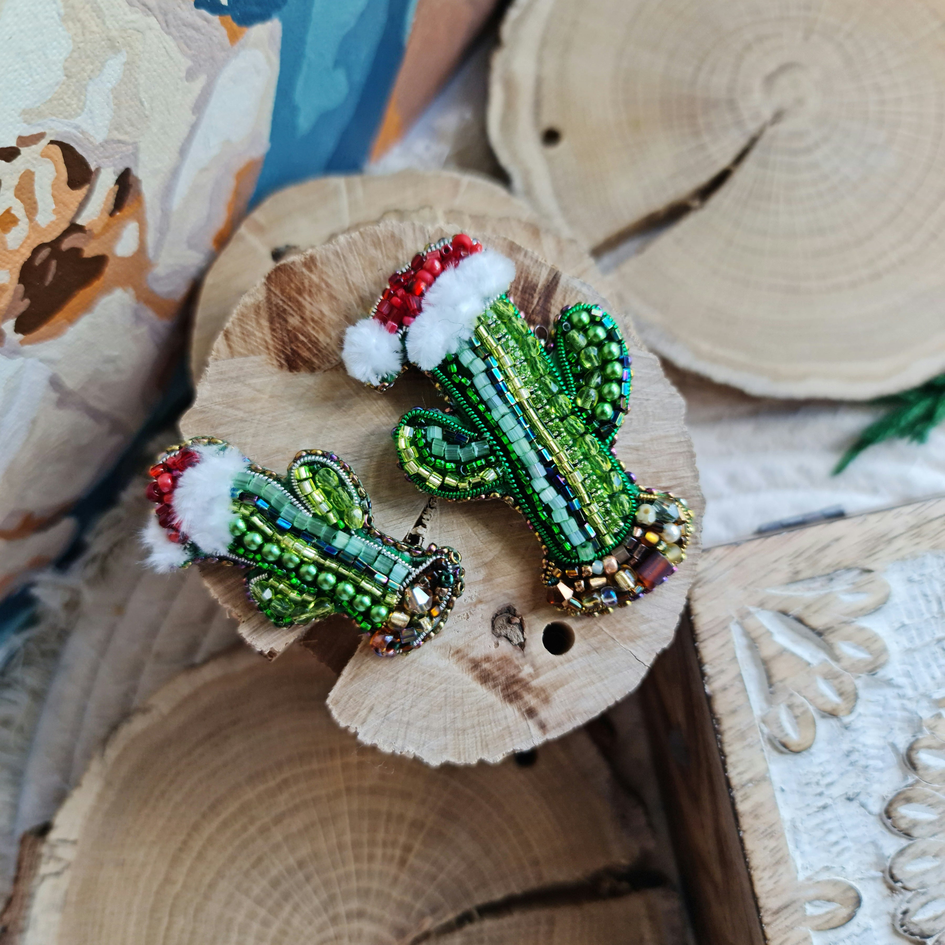 Beaded cactus brooch on a wooden surface