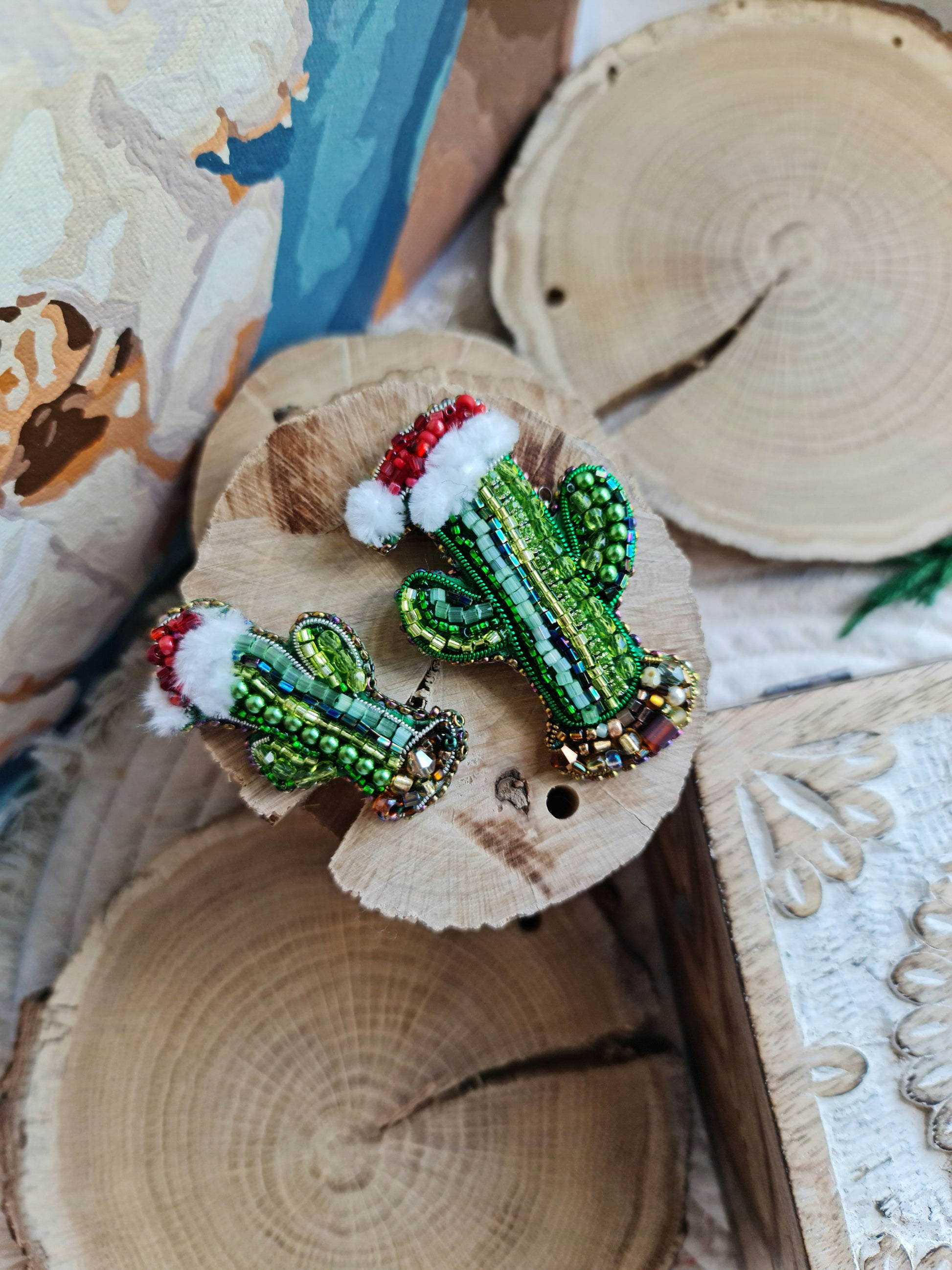 Beaded cactus brooch on a wooden surface