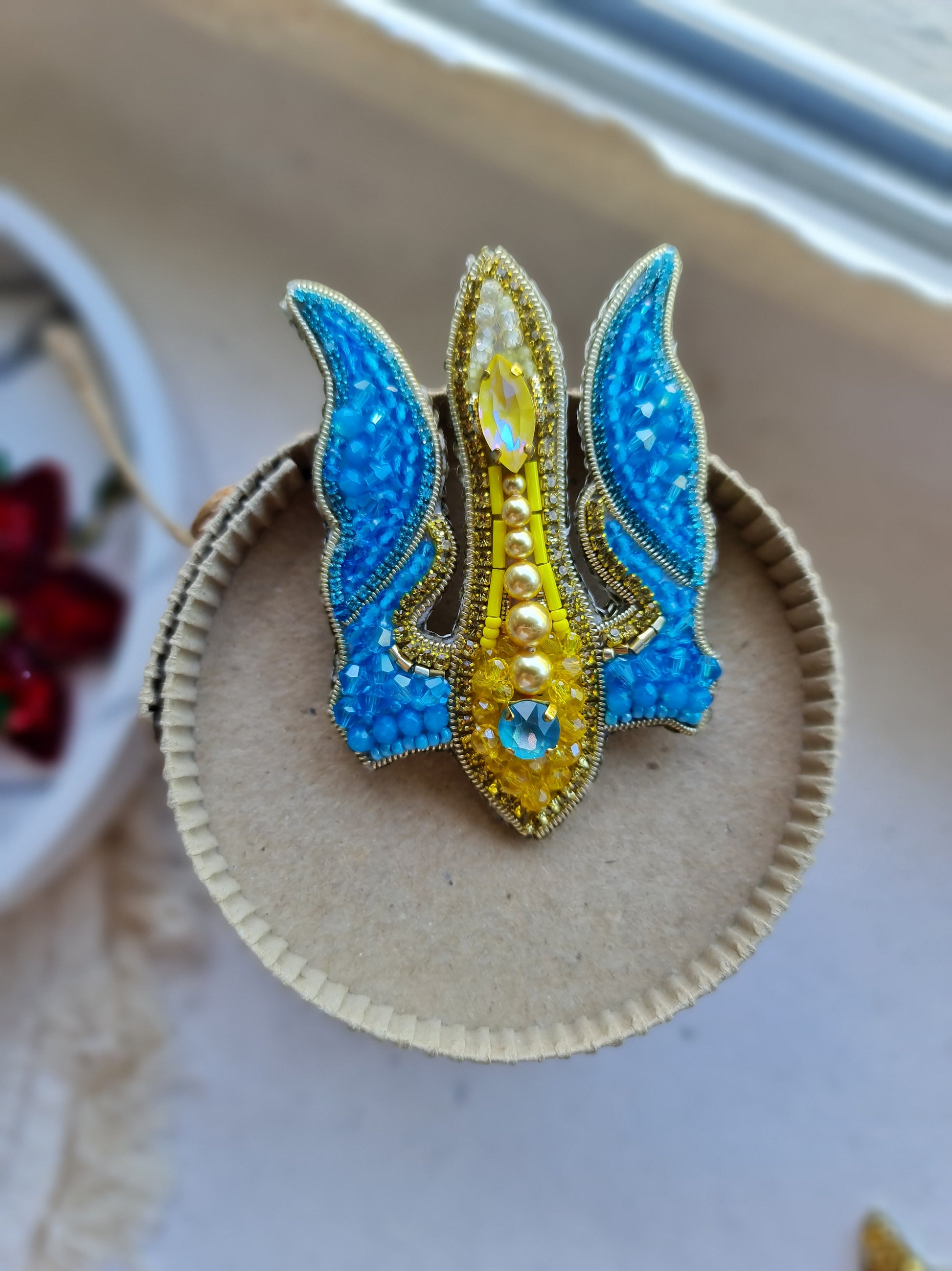 Blue and yellow trident beaded brooch hand embroidered with crystals, pearls, glass beads, and sparkling Ukraine-inspired details