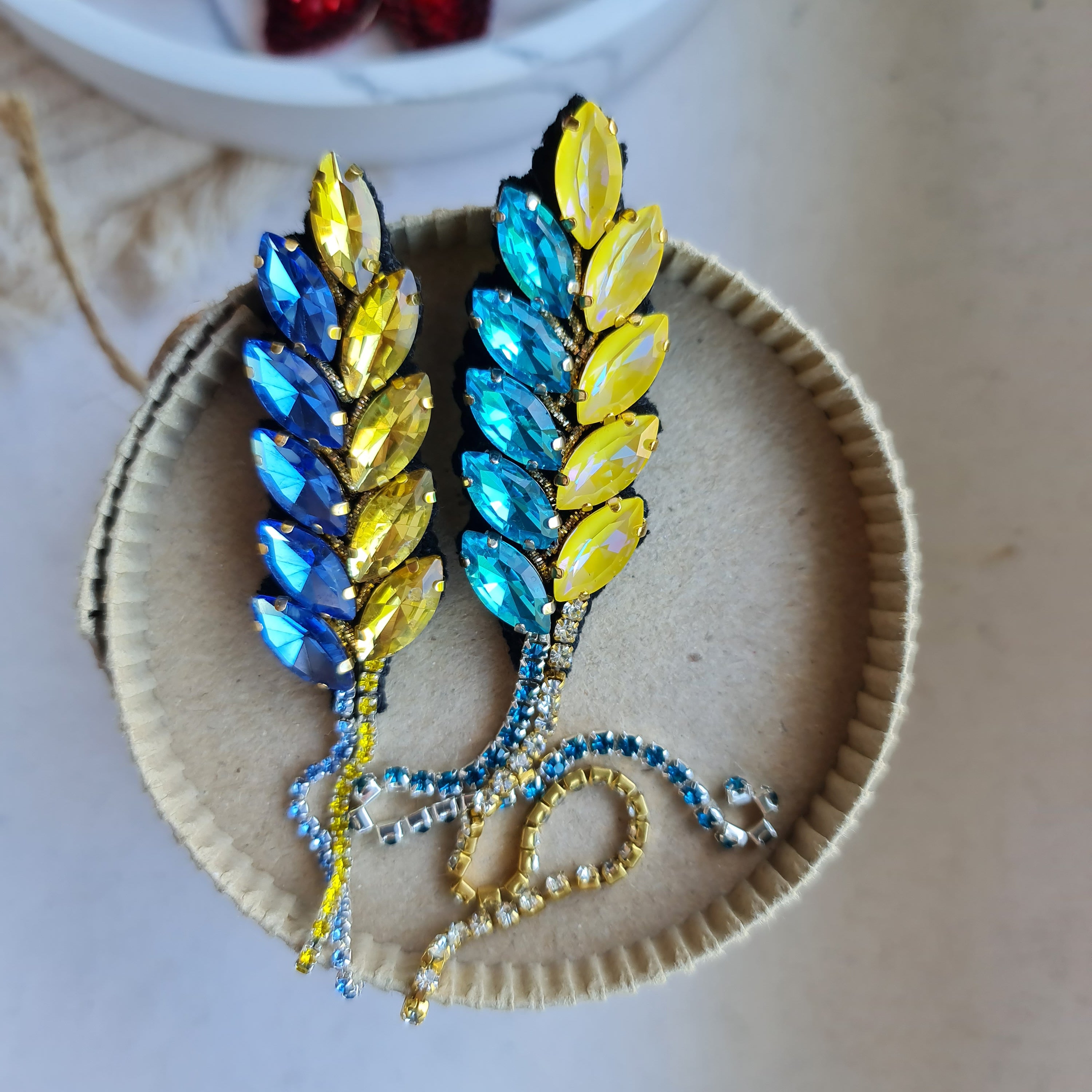 Decorative brooch with colorful stones on a textured surface