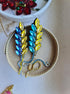 Decorative brooch with colorful stones on a textured surface