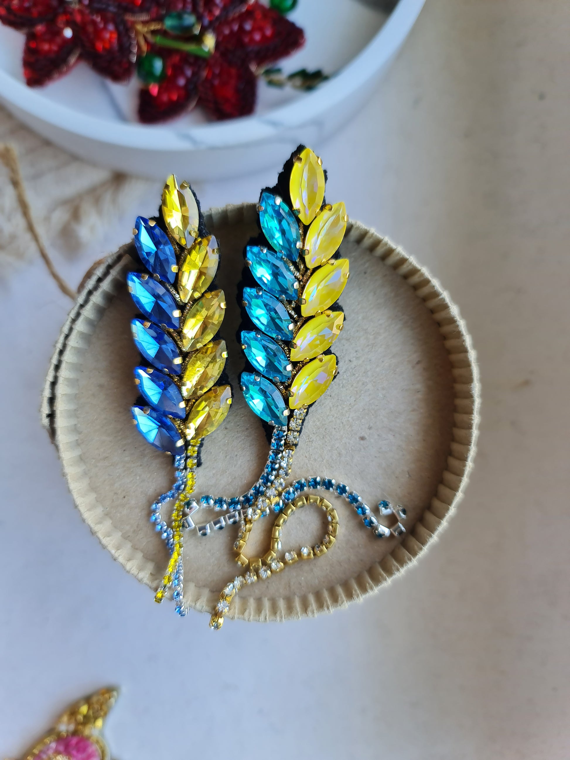 Decorative brooch with colorful stones on a textured surface