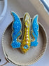Blue and yellow trident beaded brooch hand embroidered with crystals, pearls, glass beads, and sparkling Ukraine-inspired details