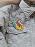 Model wearing the Anatomical Heart Embroidered Brooch pinned on a jacket, highlighting its artistic design and craftsmanship