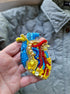 Close-up of the anatomical heart brooch showing detailed stitching and vibrant embroidered patterns.